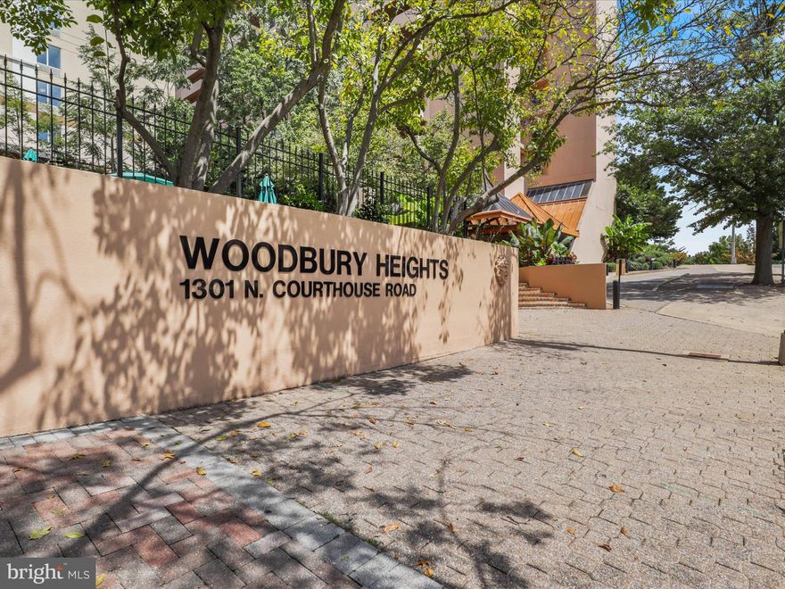 Live in elegance in this gorgeous, spacious and updated two-bedroom, two-full bath condo in Arlington's popular and highly convenient Courthouse neighborhood. Unit 1008 in amenity rich Woodbury Heights has a generous open floor plan unfolding across more than 1,100 square feet, offering a large living room, distinct dining area, and sizable bedrooms with plentiful organized closet space. The bedrooms are separated by the main living spaces, located on each end of the apartment, both having direct access to updated bathrooms. The modern kitchen features brand new cabinets, stainless steel appliances, and granite countertops.  Beautiful wood floors flow throughout the condo.  An in-unit washer-dryer makes doing laundry convenient. Rounding out the expanse of this home is a generously sized balcony for private, outdoor enjoyment.  The apartment conveys with a garage parking space, and a storage unit. Woodbury Heights is a full-service building featuring a concierge desk, on-site management, fitness room, sauna and outdoor pool. Two dogs or cats per unit are permitted. Finally, with all that unit 1008 and Woodbury Heights has to offer you'll be even more delighted with quick access to dining, shopping, the farmer's market, Metro, and points throughout the D.C. region.