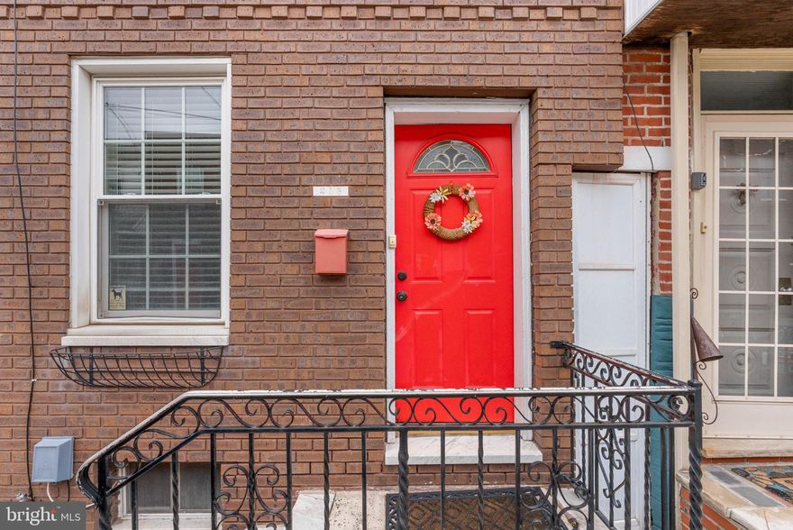 Tucked away on a quiet block, just off E Moymensing Ave in booming Pennsport, you'll find 215 Gerritt St. This move-in-ready, 2-story home has 2 bedrooms, 1 bathroom, and modern updates throughout. A classic brick facade, elevated entry, and vibrant red door welcome you out front. Inside, gleaming hardwood floors stretch across the open main level. There's plenty of space to create separate living and dining areas, perfect for entertaining. The large, sunlit kitchen is fitted with white shaker cabinetry, stainless steel appliances including a dishwasher, granite counters, a tile backsplash, and extra room for a rolling cart or table. Out back, there's a private patio. Up on the second level, a spacious primary bedroom is at the front, boasting modern floors and a pair of bright windows. Off the stairs is another bedroom and an updated full bathroom. Completing the home is a basement with lots of storage space and the laundry. 215 Gerritt St's fantastic location earns a Walk Score of 91! Local favorite restaurants and shops like Cake and Joe, Jaxx Steaks Taproom, and Herman's Coffee are right around the corner. Idyllic parks and playgrounds are a short stroll, plus nearby shopping along Columbus Blvd includes Target, Acme, Wine & Spirits, Ikea, and Lowe's. There's also easy access to public transit, Washington Ave, I-95, and South Jersey. Schedule your tour today
