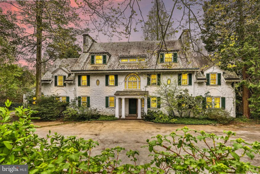 Welcome to 420 West Mermaid Lane, a truly spectacular property, in the most desirable Chestnut Hill location, beautifully sited on 1 acre. Dating to around 1910, the structure is one of a cluster of five, all in differing styles, built when the railway line from Philadelphia began radiating beyond the city. A modified Georgian style three story stone house in suburban Chestnut Hill on a lovely tree lined street.  This exquisite center hall home features a brightly lit, gracious floor plan with coveted architectural details and moldings, and seven fireplaces throughout the home. Upon entering the large two-story foyer, one is embraced by the home's charm and elegance. You will first be met by French doors leading out back and a grand sweeping staircase with a beautiful arched window above. The long formal dining room with a wood burning fireplace and large original glass window seats overlook the terrace and lush surrounding landscape. On the other side of the entry foyer is the expansive main living room, large enough for two sitting areas and a grand piano. A lovely garden room flows off the living room and offers views of the back terrace, in ground pool and property's specimen trees. A cozy wood paneled study with fire place and custom milled bookshelves can be accessed from the garden room or living room.  Also on the first floor is a powder room, rear stairwell to the quarters on the second and third floors, butler’s pantry and a large eat-in kitchen. The kitchen connects to a laundry room with extra storage and a separate mudroom. From the mudroom, one can exit to the side driveway that leads to a detached two-car garage with a separate entrance around the back of the garage to a room atop that could easily be converted to additional living space.  The back of the home opens to terraces and natural light washes over these rooms, creating an uplifting atmosphere in all seasons.   On the second floor, there are a total of five bedrooms, four full baths and a very large linen closet. Each bedroom is uniquely connected to one of the four full baths and four of the bedrooms have an original wood burning fireplace. The unique layout allows for your choice of which bedroom would serve best as a master for you.  The third floor can be accessed by the rear stairwell and on the upper floor are three additional bedrooms, two full baths and two large storage closets.   The grounds are stunning, with many specimen trees, perennials, over 1000 planted bulbs, and a spacious driveway for guest parking.  The current owners have created a pocket of English charm throughout the gardens with naturally placed mature plantings, shrubs and stunning canopy trees. The expansive bluestone terraces, tiered lawns, stone steps and lovely pool create the perfect setting for an outside oasis and enjoyment of an extremely private setting. The location is convenient only a few minutes away from Chestnut Hill Village, public transportation and the riding trails of Wissahickon Park. Easy commute to Philadelphia and Manhattan. A truly special home steeped in the tradition of the past and one perfect for entertaining and family life.