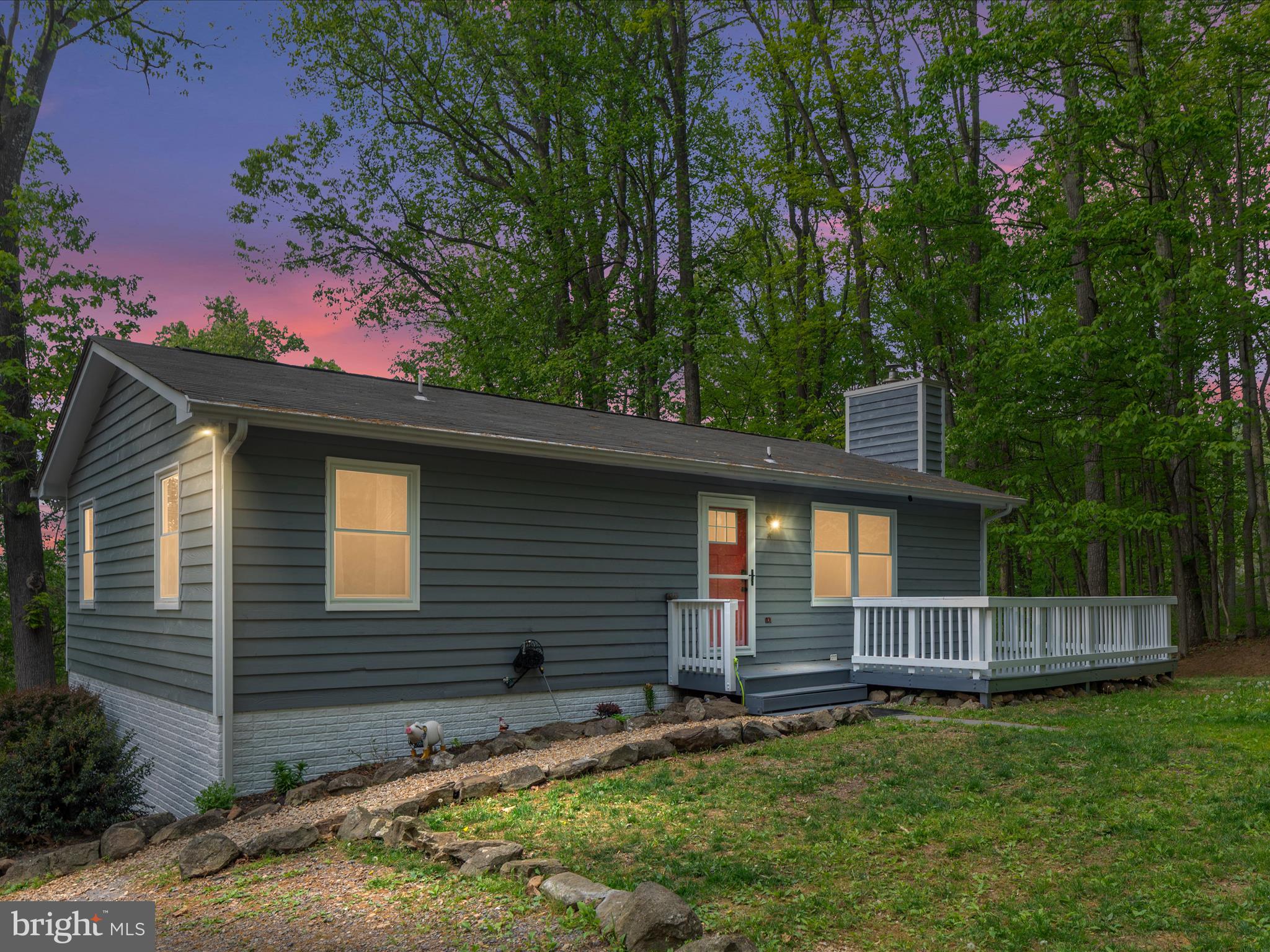 FULLY RENOVATED! Nothing to do but move in and enjoy this fantastic mountain property with easy access to I-66 and county-maintained road. Just minutes to the low water bridge boat ramp on the Shenandoah River, Skyline Drive and the Appalachian Trail. Every bit of this home has been touched including freshly painted and sealed exterior, roof replaced in 2018, new chimney cap & crown in 2022, electric heat pump 2019, windows 2023, hot water tank 2018, pressure tank 2024. Come inside from the large welcoming front deck to a gorgeous open concept featuring a newly remodeled custom kitchen boasting a large island with bar seating, upgraded countertops and high-end appliances. Cozy wood burning fireplace insert in the living room opens to a dining area and access to the back deck offering a great outdoor entertaining space with winter mountain views. Interior freshly painted, baseboard and crown moldings replaced, lighting and electrical switches/outlets updated, and luxury vinyl plank flooring installed throughout the main floor in 2024. All bathrooms were also remodeled with new fixtures, vanities, and custom tile. Walkout basement has additional finished space including a 3rd bedroom, full bath, office, and gym/flex space. Step outside to the patio from the basement. 10x17 shed conveys. Private setting surrounded by woods, wild berries and mushrooms. Lots of birds and wildlife to observe. No HOA! Roads well maintained year-round by Skyland Estates Sanitary District. High speed internet available. Sold strictly 'as is'. Inspection for info purposes only w/ option to void. Shown by appointment only, please do not drive up the driveway.