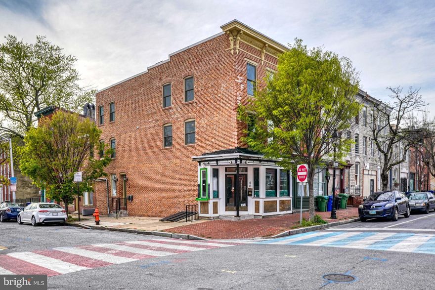 NOW AVAILABLE!  BUYER COULD NOT GET FINANCING Welcome to this solid brick end of the group building in the busling neighborhood of Hollins Market. This high profile building presents a great  investment opportunity and is well located just across the street from the newly renovated Hollins Market.  Perfect for the investor seeking to do little work to yield a nice cash flow.  The first floor is commercial space was previously used as a juice bar and the rear commercial space was a community meeting room.  The upper levels feature 2 nicely finished apartments completely with a rental license.  Don't miss out on this ready to use building located on prime corner.   Join the rejuventation and vibrance of the area!
