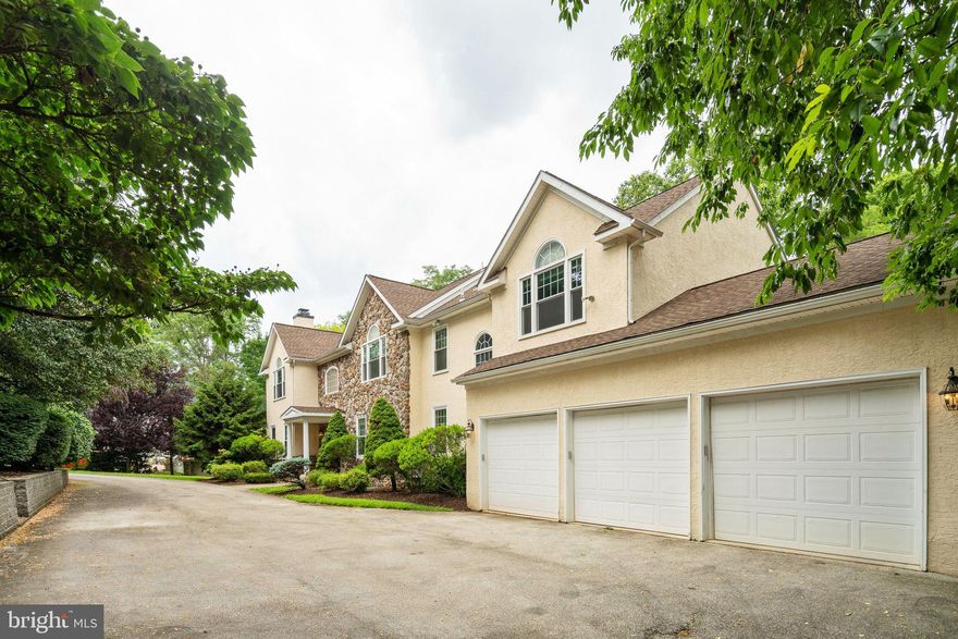 Welcome to this incredible custom built home in Villanova! You will be welcomed to a private tree-lined street which takes you to this incredible home with luxurious amenities! Step inside to the beautiful foyer and grand staircase with a magnificent chandelier. This level has many features including a gourmet eat in kitchen complete with custom cabinetry and pantry, as well as countless incredible features, you may want to put an apron on and start cooking right away! These features include an extra large island, dual-fuel cooktop (gas rings plus electric grill), downdraft vent, wall oven with convertible microwave/convection oven, dual sinks, pendant lighting, granite countertops and stainless steel appliances including a sub zero fridge. This level of the home is absolutely drenched in natural light from the large windows throughout. From the kitchen continue to the large family room with a gas fireplace and a custom wall unit built in. From there you can step outside through multiple sliding glass doors onto your Trex Deck which extends from the family room to the kitchen. Make sure to bring a cup of coffee or glass of wine with you to relax while overlooking your secluded backyard. Other highlights on this floor are a spacious dining room, two conveniently located half bathrooms, a full laundry room with tons of storage and a pet wash station, a fantastic feature if you have any 4 legged family members! You will also find direct entry to your three car garage showcasing a full garage tech organization system with floating storage box and an electric car hook up! Head to the upper level and walk into the massive primary suite which reveals not only a large bedroom with enough space for a sitting area but also dual walk-in closets with built-ins. Now take a step into the bathroom with a jacuzzi tub, dual vanity, toilet room and a one of a kind shower cave with five body sprayers! This level of the home also boasts an additional four large bedrooms, a lot of closet space, all including built-in’s and three full baths. Walk down either staircase to the fully finished lower level which showcases a huge media room with built-in speakers, a wet bar which includes a small kitchenette and a granite breakfast bar, a workshop with sink and access to a half bath with dual doors. The workshop also has a vault security room as does the hallway outside with both doors having reinforced framing. There is also an additional bedroom with a full bath with dual doors, and a large storage area. You can also walk directly out to your secluded backyard when on this level. This home is located in the top-rated and Award Winning Radnor School District and is close to Main Line dining, shopping and entertainment, Villanova campus, Whole Foods, Trader Joe’s and so much more as well as convenient to major highways. Reach out for your private showing today.