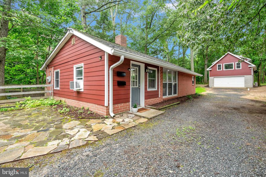 Arden on the Severn — a rare opportunity in a highly sought-after water-oriented community located on the Severn River. Main home is a one-level ranch featuring two bedrooms and one full bathroom, while the third bedroom and second full bathroom are located in a private studio apartment, above the detached two-car garage. Complete with kitchen, washer and dryer, and balcony overlooking a wooded area, the possibilities for this separate living space are endless. The main home, centered around a brick chimney with wood stove, offers an open floor plan filled with charm, character and natural light. A fenced yard, garden shed and peaceful surroundings create an oasis, close to Beach 5. New well installed Fall of 2024. Arden residents enjoying exclusive access to all neighborhood beaches, boat ramps, playgrounds and scenic waterfront recreation. Enjoy the Arden lifestyle and everything this vibrant water-privileged community has to offer. Don’t miss your opportunity to live in one of Crownsville’s most desirable neighborhoods!