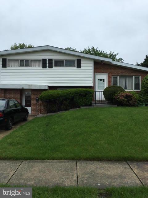 Beautiful Brick-front Split Level home with gleaming hardwood floors on main and upper level. Eat-in kitchen with ceramic tile. 3 spacious bedrooms and 2 updated full bathrooms. In-law apartment with full kitchen and laundry on lower level with separate outside entrance. Spacious screened-in side porch. Huge fenced yard in rear.