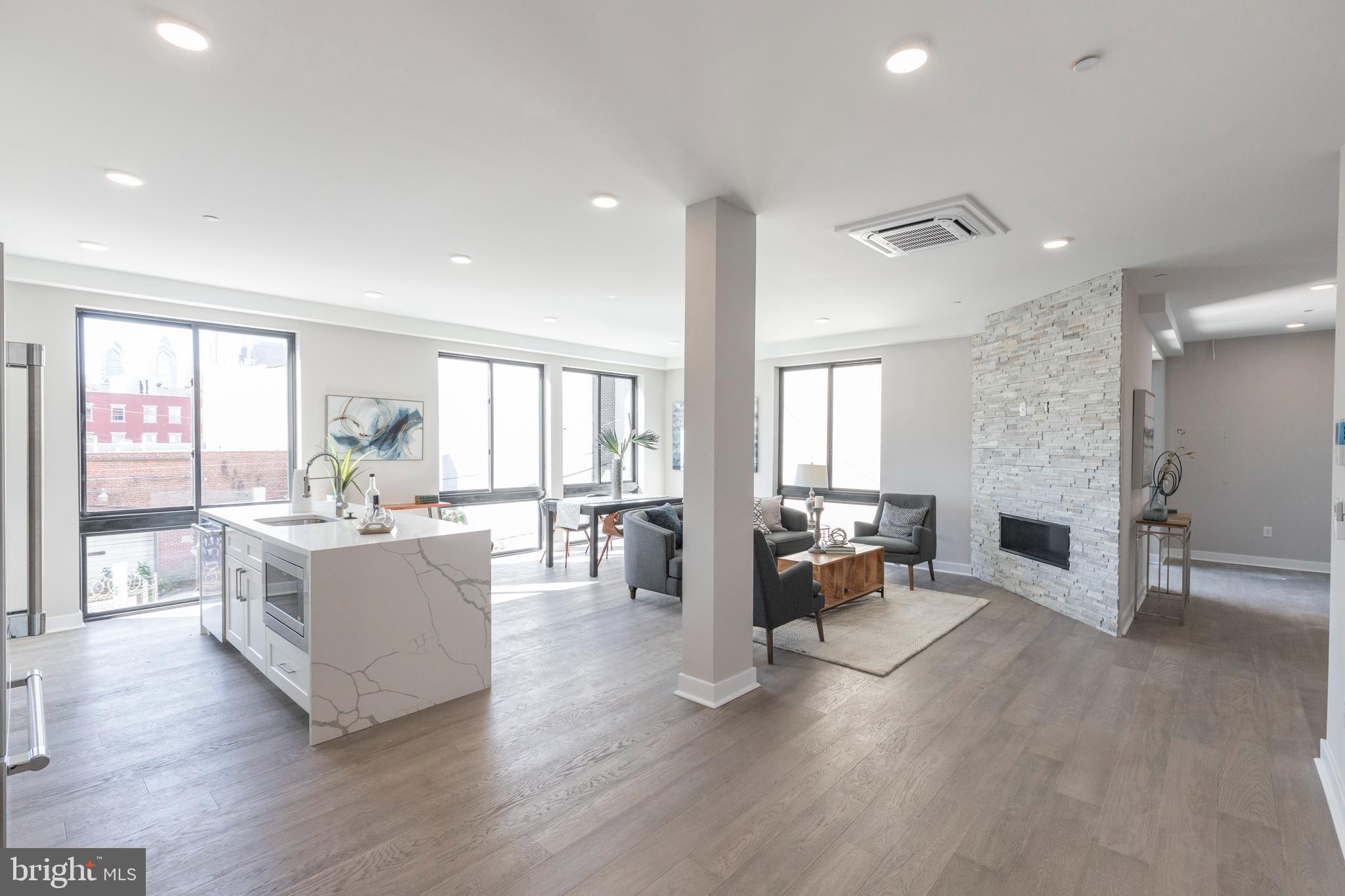Discover the amenities and luxury afforded by the condos at the Views on Swain. Located at 716 N. 15th Street, at the corner of N 15th and Swain Streets, the new-construction units in this boutique 5 residence luxury condo building have it all: privacy, thoughtful design, fine finishes and spectacular views. Unit 5 is accessed by a commercial-grade elevator providing convenient and secure access directly to the unit. Step off into a spacious open living area with gas fireplace and a south facing wall of floor-to-ceiling windows offering breadth-taking Center City views. The open layout flows into a designer kitchen with everything expected in high end construction: sleek white cabinetry, glass tile backsplash, a Jenn Air stainless appliance package, quartz countertops and a waterfall island accommodating bar seating. Down the hall past the laundry/utility closet is a 3-piece hall bath,with tub, that is adjacent to a secondary bedroom that is spacious enough to serve double function as an office and bedroom. Finally, there is the primary bedroom. Situated in the southeast corner, it has windows on 2 sides, a walk-in closet and an en suite bath with porcelain tile, a dual wall-hung vanity and spacious double shower enclosure with rain head. Nearly as appealing as the aforementioned finishes and other upgrades like the state of the art sound-proofing and the highly efficient cassette multi-zone HVAC system is the building’s convenient location. Located near all that is happening on the eastern end of Fairmont Avenue and the Avenue of the Arts North, it is but a short walk to Center City, close to public transportation (1 block to the Broad Steet Subway), and in proximity to Kelly Drive and Fairmount Park. Building units come with a 10-year tax abatement and 1-year builder's warranty. **Taxes and Condo Fees are estimates only.