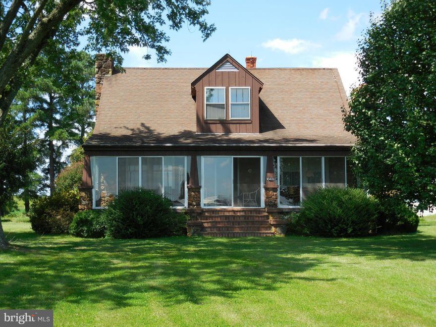 Lovely old stone house on 1.6 acres. Detached 2 car garage with work shop. Large storage building at back of lot.  Home has hardwood floors through out. Kitchen has breakfast nook and separate dining room.  Large enclosed glass front porch with heat to used year round.  Basement has wood stove. House needs some updating but has a great set of bones.