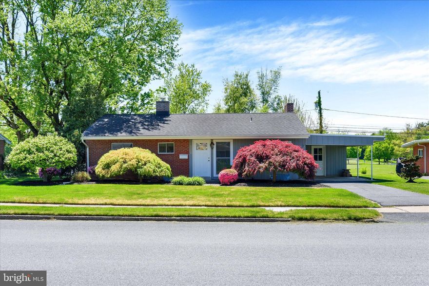 Welcome to this lovely ranch home nestled in the heart of Camp Hill Boro! This charming residence offers comfortable one-level living with timeless features throughout. Step inside to find a warm and inviting family room complete with hardwood floors, crown molding, built-ins, window treatments, and a cozy wood-burning fireplace—perfect for relaxing or entertaining. The kitchen is outfitted with engineered hardwood floors and window treatments, offering both style and functionality. This home features three generously sized bedrooms and a full bath, providing ample space for everyday living. Step out into the bright and airy sunroom with a ceiling fan—an ideal spot to unwind—which also offers the potential to be converted into additional living space. From here, make your way out onto a luxurious paver patio overlooking the cleared, level backyard—perfect for outdoor gatherings or quiet evenings at home. The unfinished basement includes a utility sink and provides excellent storage opportunities. A one-car carport with an attached storage area, along with a paved driveway, ensures plenty of parking. Conveniently located near shopping, dining, entertainment, and all that Camp Hill has to offer. Roof replaced in 2017. A joy to own!