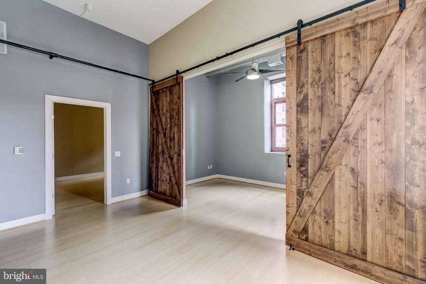 Welcome to The Rombro Loft building, a beautiful condo building in the heart of downtown and steps away from University of Maryland campus, Oriole Park, Restaurants, Ridgelys Delight and more. This condo has been remodeled and you won't find another like it in the building! The condo features stunning barn doors, 2 large bedrooms, walk-in closets with custom built-in's, bamboo flooring, fresh paint, W/D in unit, souring ceilings, large windows, SS appliances and a great view of the Bromo Seltzer Arts Tower! The building does not have it's own parking garage, however there are garages on all sides of the building and across the street - spaces can be rented. Vacant and ready for move in! Call today to schedule a private tour.