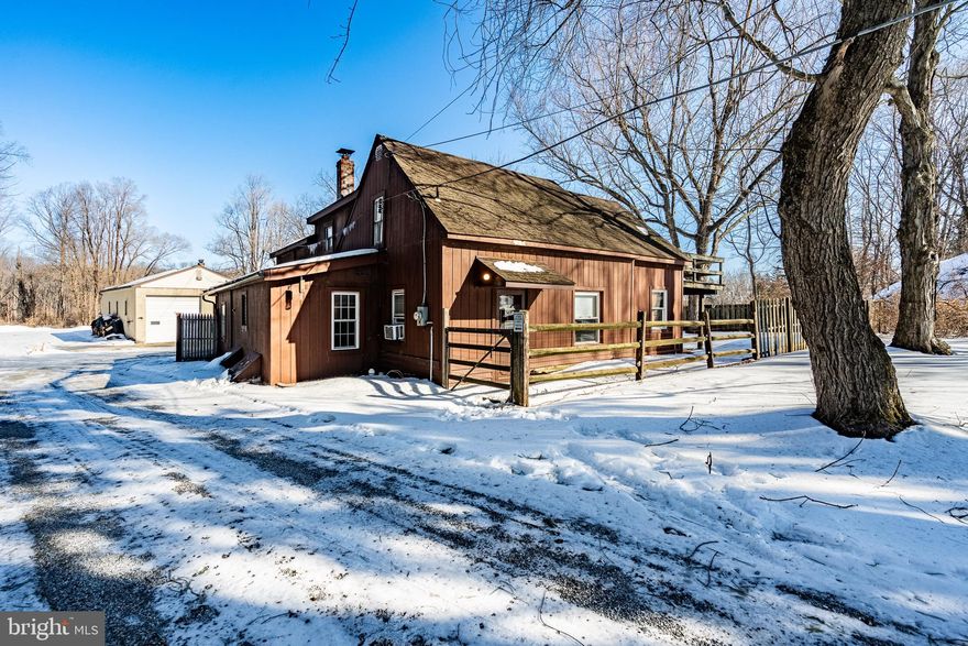 Nestled on a peaceful one-acre lot in West Chester this charming 3 bedroom, 2 full bathroom Cape Cod home (with a MASSIVE detached garage) exudes timeless character ready for you to make it your own!  Entering the home from a long private driveway that leads to a lot that fits 5+ vehicles, you will see the home that sits forefront and conveniently close to the garage space in the rear. 
Inside, the home exudes cozy character, highlighted by exposed wooden beams that add rustic elegance and a sense of history throughout key living spaces.
The standout family room is exceptionally charming and cozy, with a  pellet stove that provides efficient, flickering warmth on chilly evenings like these! —perfect for gathering with loved ones. The room's thoughtful design creates an intimate, lived-in atmosphere ideal for relaxing or entertaining.
A unique pair of spiral staircase adds a touch of whimsy and architectural interest, each one gracefully connecting the main level to the 2 second story private bedrooms while saving space and enhancing the home's distinctive personality (1 bedroom in on the first stroy).  To the side stands an impressive, one of a kind, 1377-square-foot detached garage, a true standout with its soaring 14-foot ceilings that create an airy, versatile workspace perfect for accommodating a car lift, woodworking shop, classic car restoration, landscaping or almost any large-scale hobby. Fully equipped with electrical throughout, dedicated office space, reliable heating, and a half bathroom, the building functions as much more than storage—it's a practical retreat that offers connivence and ease.  Together, the property offers a rare blend of historic charm and modern utility, all spread across generous acreage that feels worlds away from the bustle yet remains conveniently close to West Chester's vibrant downtown.