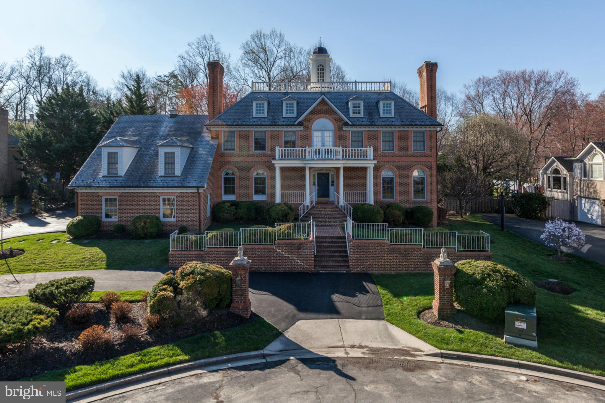 A stately, Williamsburg replica exterior belies a more modern, open flr plan inside. Custom built, this home offers exceptional construction, lrg rooms & a circular flr plan. Exquisite details - thick crown moldings, 5 fireplaces incl a carved marble LR FP. Ahead of it's time, It has all you want today- 9'+ ceilings, a 3 car garage, a w/o lwr lvl, private au pair/inlaw suite + an ideal location!