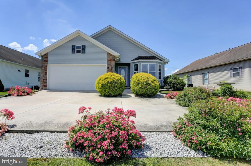 Prepare to be wowed by this stunning Oakmont model ranch home in Shippensburg’s sought after gated 55+ Country Manor Adult Community. It has three bedrooms, two full baths, and a sunroom that overlooks the community pond. Step inside the foyer to take in the full view all the way to the back of the home and notice the newer vinyl plank wood-looking floors that run throughout. The roomy kitchen has been remodeled with newer vinyl tile floors, granite counters, and brand-new stainless, finger-printless appliances and includes a pantry with roll-out shelves. Enjoy casual dining in the kitchen’s large bay window area. The dining and living room open concept areas are light and bright with a stone gas fireplace as the focal point. The cheery sunroom opens out on your large fenced in patio, perfect for sitting outside watching the fountain in the center of the pond. There is also a smaller fenced grass, area perfect a small pup. The generous primary bedroom includes an en-suite bath with two sink vanity, a large walk-in closet, and walk-in shower with seats. You will find two more bedrooms and a second full bath complete the layout. The laundry room off the hall leads to your spacious two car garage, both freshly painted. This economical home has natural gas forced hot air and central AC. The community offers a tastefully appointed club house featuring a large room for personal or community gatherings, full kitchen with island, cozy gas fireplace, community run activities and library, and for an extra fee fitness room access. Other community amenities include security gates at all entrances, a screened-in gazebo overlooking the mountain and stocked fishpond with fountain, yard games and walking trails. This exclusive, quiet lifestyle comes with a monthly fee of $583 and includes sewer, trash, and recycling. Your full ownership of the home includes a 29-year renewable land lease for your lot. Pets are welcome and limited to two per household. Conveniently located to lots of shopping, restaurants, entertainment, golf, doctors and hospitals, and major highways.