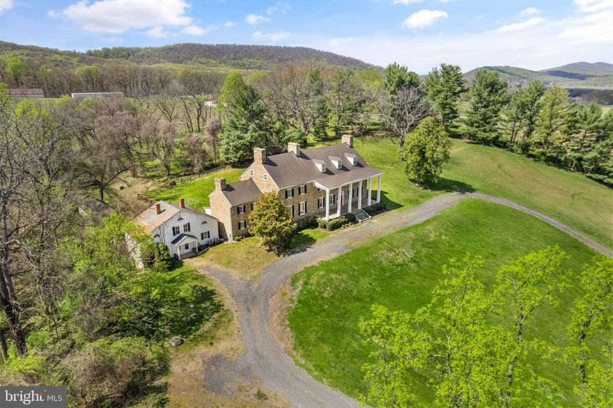 BRING YOUR OFFER & START YOUR OWN CHAPTER AT CHESTNUT HILL HISTORIC HOUSE! Nestled on 20.02 acres in Leesburg, Virginia, the Chestnut Hill Stone House is an extraordinary Pre-Revolutionary Federal-Style Mansion, built circa 1766. Featured on NBC4 News, this breathtaking estate offers over 7,500 square feet of elegant living space, blending timeless historic charm with modern comforts along with a Carriage house suitable for guests or as rental income, a stable and additional outbuildings. Perched on a scenic knoll with sweeping mountain views, this property is an incredible property rich with legacy! 

Once the residence of Thomson Francis Mason, esteemed lawyer, and former mayor of Alexandria, Chestnut Hill is steeped in a rich historical narrative that spans centuries. As the grandson of founding father George Mason IV, Mason's legacy is felt throughout the property, with his initials, TFM, etched in the original glass of the home *** Constructed in 1766, this stucco-covered, two-story fieldstone home has been expanded by subsequent owners, including the Mason family who occupied the estate for nearly a century. According to local oral history, the home was spared from destruction during the Union's Civil War orders due to the reverence for the Mason name. It is believed that an original copy of the Virginia Declaration of Rights was housed at Chestnut Hill during the family's ownership before being sold to the National Archives in 1930. ** This estate offers a rare opportunity to own a piece of American history while enjoying modern comforts. The home is rich in architectural significance, featuring original windows, intricate trim work, soaring ceilings, wood flooring, charming built-in cabinetry, and a total of eleven fireplaces that add warmth and character. With five bedrooms and five and a half baths spread across five levels, this residence is both grand and inviting. ** The estate also includes a variety of historic outbuildings, including a carriage house with three additional bedrooms and a full bath—ideal for guests or rental income—a dairy structure, stable, spring house and a family cemetery dating back to the 19th century.  Entertain in style with a grand stone front porch adorned with five tall columns, and a spacious rear porch offering picturesque views of the surrounding landscape. ** Chestnut Hill’s historical significance is enhanced by its connection to notable figures like Colonel Josias Clapham, the Mason family, and Coleman Gore, the uncle of Vice President Al Gore. Zoned AR1 and subject to covenants, this property offers timeless elegance, modern convenience, and easy access to Loudoun County's renowned wineries, breweries, and historic downtown Leesburg. This is more than just a home—it's a living testament to Virginia's storied past, offering a unique opportunity to create your own history within its walls. Property sold in as-is condition. Seller Prefers Community Title.