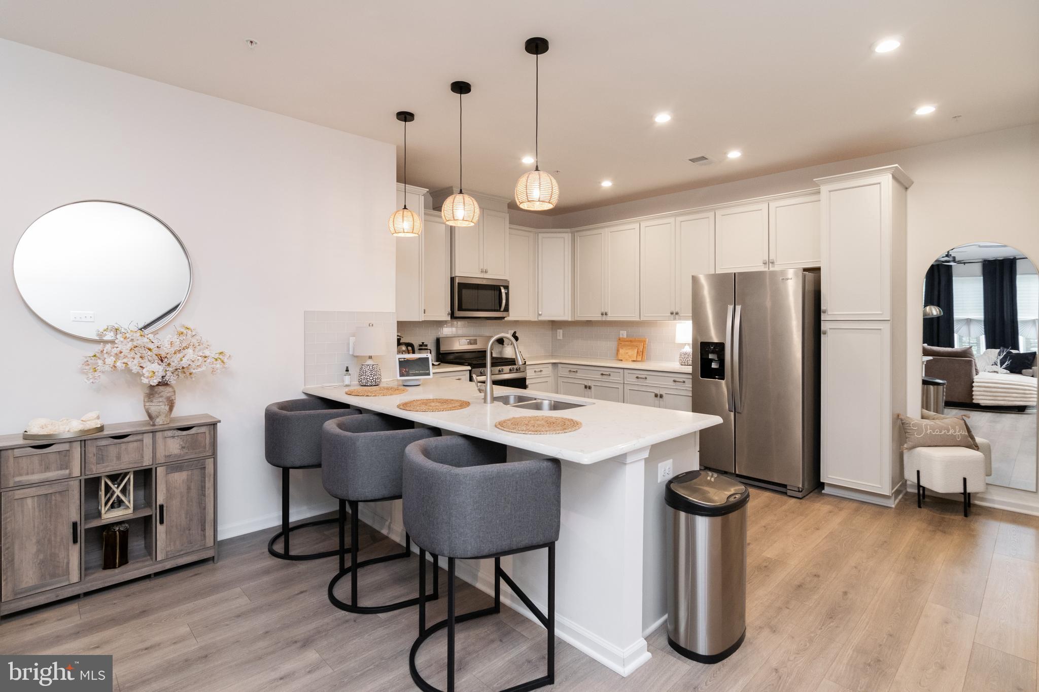 This well-maintained 3-year-old, two-level home blends modern convenience with low-maintenance living. Offering 2 bedrooms and 2.5 bathrooms, it’s thoughtfully designed for those who appreciate comfort, style, and functionality—without excess.
On the main level, enjoy an open-concept layout with a sleek kitchen, updated finishes, and a cozy flow ideal for daily living or casual entertaining. Upstairs, a versatile loft opens to a private covered balcony—perfect for relaxing, working from home, or enjoying quiet moments outdoors.
The second level also includes a centrally located laundry area, two bedrooms, and two full bathrooms. The primary suite feels like a personal retreat, complete with a spa-like bathroom featuring dual vanities, a private water closet, an oversized shower with a built-in wrap-around bench, and a walk-in closet with a custom organization system.
Community perks include a pool, fitness center, clubhouse, scenic trails, and tot lots. Perfectly situated near Fort Meade, MARC station, and BWI Airport—with easy access to major commuter routes—this move-in-ready gem offers the ideal blend of modern living and convenience.