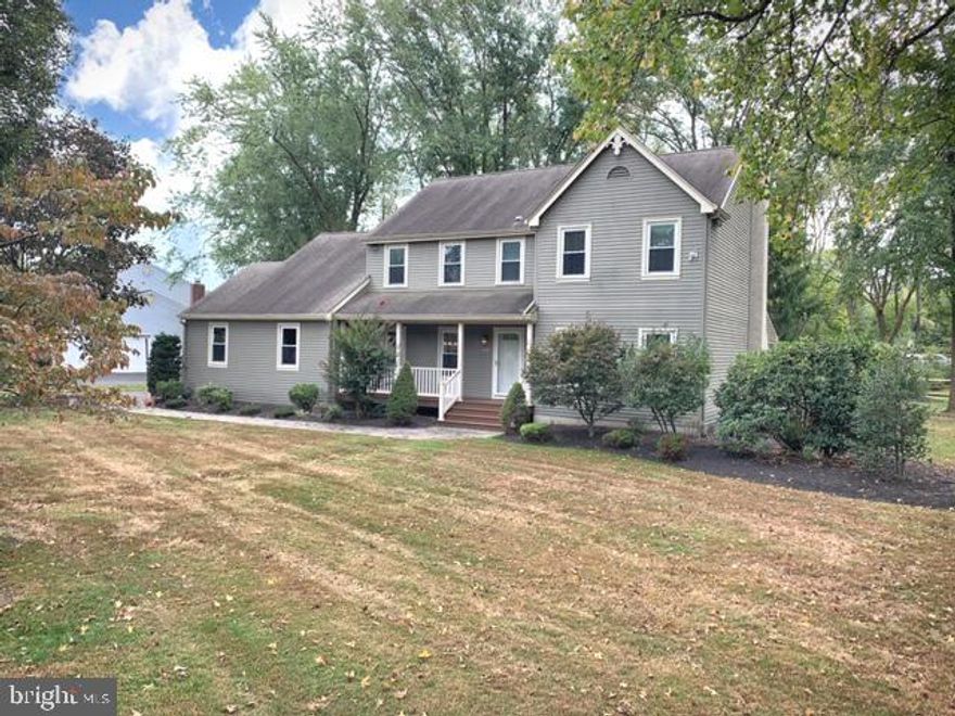 Gorgeous former model home in the  sweet spot  of Yardley! The  Wynnewood  neighborhood has it all with award-winning schools, restaurants, recreation, and EZ commuter ways just a short drive away but far enough to keep the peace & quiet at home. A curving EP Henry paver walkway leads to a welcoming entry w/covered porch, new door, & Trex deck w vinyl railings, perfect for that morning cup of coffee! Entrance hall boasts oversized coat closet, HW flooring and custom molding details. On either side of the foyer is a Formal Living Rm. w/French doors & crown molding and Dining Rm. w/hardwoods, chair rail & crown molding. Flowing from the hallway is an inviting Family Rm. w/ exposed beams, stone fireplace, built-in bookshelves, and door leading to 200+ sq. ft. screened deck overlooking parklike yard. Fall in LOVE with the totally renovated eat-in Kitchen w/custom hardwood  soft close  cabinets, quartz counters, custom back splash, porcelain flooring, new lighting, all new upper-end stainless appliances, gas cooking , 2 pantries and new exterior door to Trex deck.  A new Powder and Laundry Rm. (new washer & dryer included) with garage access finishes off the main level. Back AND front staircase lead to the expansive second level. Master en suite is bright and airy, offering a walk in closet, remodeled Bathroom w/ seamless glass shower w/ bench and built in shelf, quartz counters & porcelain floors. Attached to the Master Bedroom is a Sitting Room w/cathedral ceiling, 2 closets and staircase to lower level. Completing the upper level are 3 additional great sized bedrooms w/ large closets, a large hall linen closet and a calm beachy-themed new full Bathroom w/ lovely driftwood look porcelain floor, large closet and seamless glass shower doors attached to tub. New Bathrooms have Toto toilets & push button fan timers. Great basement space with 2 newly painted and carpeted rooms plus plenty of storage areas! Picturesque curb appeal with a .62 lot - perfect for grilling, yard games and gardening! Additional home features include neutral paint T/O, a 2-car side entry garage, newer windows, Bedroom ceiling fans, capped trim, window blinds and a security system. With an easy interior flow, amazing lot and amenities galore, this house is the perfect place to call home!