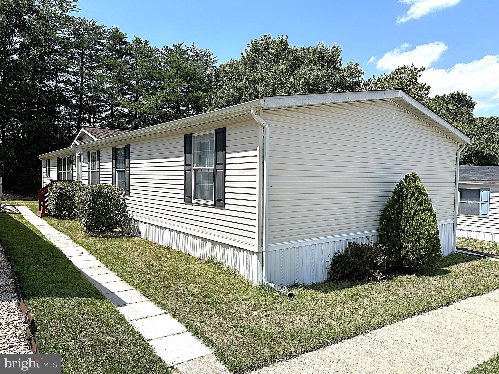 Spacious Doublewide in Sought After Holiday Mobile Estates! With Over 1900 square feet of Living Space this 4 Bedroom has a lot to offer with Generous Sized Rooms Throughout. Inside Features a Big Country Kitchen with an Eatin Area an Island and Sliding Glass Door to Outside Deck. Just off the Kitchen is a Family Room with a Wood Burning Fireplace. The Living Room is Huge and there is a Separate Formal Dining Room. You have a Big Primary Bedroom on one end of the House with a Sitting Area, Superbath, with a Corner Garden Soaking Tub, Double Shower Stall, Dual Sink Vanity and Large Walk-in Closet. On the other end are your 2nd. 3rd and 4th Bedrooms and a Hall Bath. Outside you have a Sundeck Patio and Secure Storage Shed. The Community has a Big Tot Lot along with a Basketball Court for the kids to play, Close to Schools, Restaurants and Shopping. 10 Minutes to Ft Meade and Arundel Mills. All this at a Great Price!