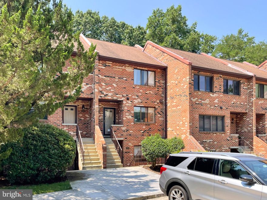 Experience the pinnacle of townhouse living in this delightful 2 story condo situated in the highly desirable Steppes of Barcroft community. Enter into a foyer with new luxury vinyl plank floors and freshly painted interiors that exude elegance and warmth. The upper-level features two sizable bedrooms, each with en-suite bathrooms and ample closet space. The carpeted stairway to the downstairs level features a fabulous brick wall. On the lower level, you will find a spacious family/living room with a wood-burning fireplace, perfect for cozy evenings. Walk out to the private patio and view the wooded common area, an ideal setting for hanging out and sipping your favorite beverage while soaking in the natural atmosphere. The open dining room concept offers ample space for a large table, perfect for casual or formal get-togethers. The white kitchen offers plenty of cabinet space, featuring new quartz counters, and new stainless-steel appliances. A powder room and full-size washer and dryer are bonus offerings on this level along with a storage closet. This quiet location offers sufficient parking for residents and guests. #418 is the dedicated space that conveys with the unit. Conveniently located a few blocks from Columbia Pike, with easy access to bus stops and shopping. Outstanding location with serene setting!