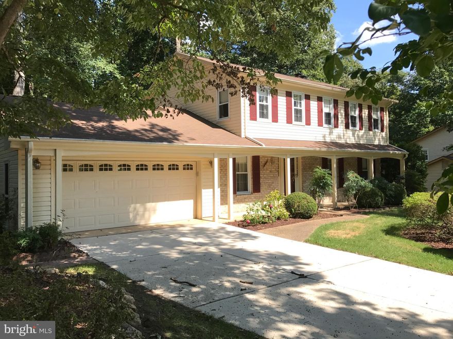 Reduced Price!  Lovely 3 level colonial home nestled on beautiful wooded lot on quiet cul-de-sac. Excellent condition Great location. 4 bedrooms, 3 baths with walk out basement to beautiful 2 level expansive deck. Brand new appliances and new carpet. Gleaming wood floors on main level. Spacious living room, den & dinning room with large eat in kitchen. New roof,  Amenities galore! Home warranty!