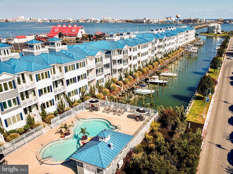 Rare opportunity to own a premium unit in the much sought after community of The Villas at Inlet Isle in West Ocean City. Absolutely PRISTINE 3,069 sq. ft. south facing luxury townhome with 35 ft. boat slip, power pedestal and dock box directly behind the unit.  Property is being sold fully furnished with a few  minor exclusions.  Incredible open bay, OC Inlet, marina, and canal views. This unit has 3 bedrooms plus a den that can be used as a 4th bedroom. Luxurious water/marina front master ensuite with sitting room, private balcony,  custom walk-in double shower, double vanities, two walk-in closets.  A total of 4 full bathrooms-all with timeless decorator selected tile and upgraded finishings. 3rd floor gourmet bay front kitchen with an approx. 13 ft. island,  two pantries, upgraded appliances,  gas stove, quartz counter tops, wine cooler, ice maker, 42 inch cabinets,  shelving, custom backsplash, and access to bay front balcony. 9 ft. ceilings, crown molding, and plenty of tall windows throughout the unit allow an abundance of natural daylight in. Professional decorator selected high end finishings and LED can lights throughout, custom wood trim walls  on each level. Cupola/rooftop deck with absolutely incredible water views. Private elevator, two car garage with quality cabinetry for additional storage, under stair storage  area, 80 inch wall mounted tv in main living area, tankless water heater, outdoor living space on every level.  This unit has too many upgrades and conveniences to list.  It’s a definite must see. Amenities include a southern exposed heated community pool with bathhouse and outdoor shower, community dock, and grass yard.  Weekly and short term rentals are not permitted. Inventory is low, don’t miss out! Book your private showing today! This gem won’t last long! NO OC property tax.