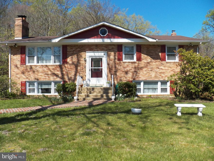 ALL BRICK HOME ESSENTIALLY ONLY 15 YEARS OLD*HOUSE WAS TOTALLY REBUILT DUE TO FIRE*GUTTED AND REBUILT*MAIN LEVEL BOASTS NICE EAT IN KIT*SEP DR*LARGE LR W/BRICK HEARTH FP*GLEAMING HARDWOOD FLOORS, 3 BR'S AND 2 FULL BA*DECK OFF UPPER LEVEL BACKING TO WOODS*DOWNSTAIRS HAS HUGE REC RM W/2ND BRICK FP, WET BAR, BEDROOM, 1/2 BA AND STORAGE*WALK OUT LEVEL TO CONCRETE PATIO*GREAT COMPLETELY UPDATED HOME