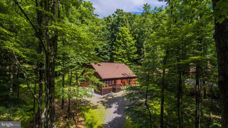 Just Completed!  The quality and custom design of this log-sided contemporary ranch retreat is "Almost Heaven". Spacious light-filled great room with vaulted ceilings, open kitchen with pantry, two master suites with full bath, one featuring heated whirlpool tub, and bonus third bedroom that could also be used as a den, office, dining room, or lockout.  Half bath just off of great room. The interior throughout features pine trim, cabinetry and flooring, with top end brand new appliances and fixtures, including washer and dryer. Central air and heat, wired for phone, cable, and alarm system, plus storage attic with easy access.The exterior includes both a generous screened front porch and rear deck, with fireplace foundation for great room. Nestled in the relaxing nature oriented Coolfont Mountainside Community, which backs up to Cacapon State Park. The Coolfont Mountainside Community features events, pool, tennis and hiking trails. The popular Coolfont Resort and Spa, within walking distance, is currently being restored, opening date to be determined. The Coolfont Mountainside Community is approximately 10 minutes from Berkeley Springs with it's historic mineral baths and artist community. Cacapon State Park is approximately an 8 mile drive. Cacapon offers lodge dining, golfing, fishing, hiking, clay sports shooting, swimming, tennis and basketball courts.