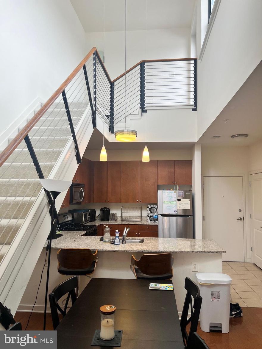 Gorgeous modern unit in Village Lofts. This is one of the few with a private roof deck, you won't believe how large it is! Also included is a parking spot in the attached and secured garage, with direct building access.

This unit has a modern kitchen with gas cooking and seating at the counter.  The dining area and living room are so nice and open! There's an in-unit washer/dryer, and two generously sized bedrooms, both with attached baths. The primary bedroom features a walk-in closet and a very large bathroom with double vanities and large shower.  The 2nd bedroom has two closets, and attaches to a large bath, which is also accessible from the main living area. 
Come see this today before it's gone!
