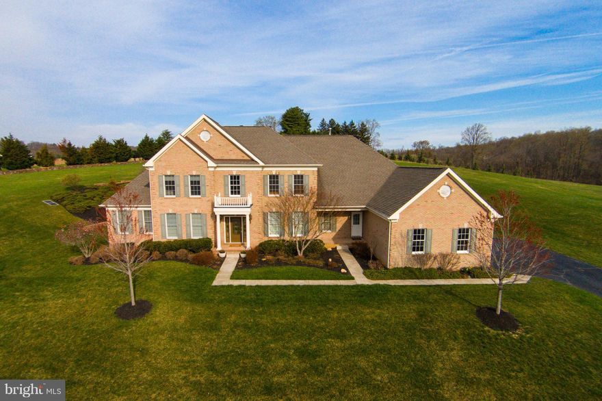 AMAZING 40K PRICE REDUCTION!!! Recently updated, this 3-sided brick Estate home is move-in ready! Hardwood floors are featured through most of the main level, gourmet kitchen w/ access to a new deck is just off the breakfast area for your outdoor living & dining. Stunning backdrop with terraced stone path to upper lawn featuring sweeping views of the area.Spacious bedrooms all with en-suite baths.