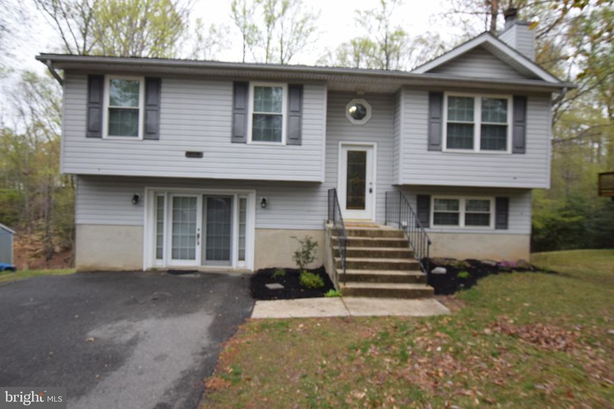 Welcome to your dream home in a vibrant community offering amenities for every lifestyle. Located on a quiet street just minutes from Solomons Island, Patuxent River Naval Air Station, and commuter routes to Washington, D.C., and Annapolis, this beautifully maintained split foyer offers two fully finished levels and a host of desirable features.
Inside, you'll find no carpet, adding a clean feel and easy maintenance. The main level boasts vaulted ceilings in the living room, which opens to the dining area and updated kitchen. The kitchen features stainless steel appliances, granite countertops, a center island, and easy access to the large screened-in porch—perfect for entertaining or enjoying peaceful mornings. This level also includes three bedrooms and two full bathrooms, including a primary suite with a private bath.
Downstairs, the finished lower level offers a spacious rec room with bar, a flexible room ideal for a guest room, office, or gym, a third full bath, laundry area, and extra storage.  In addition, the property features a geothermal heating system, helping to reduce electric bills and improve energy efficiency year-round.
Chesapeake Ranch Estates offers an impressive array of community amenities, including a sandy beach, a freshwater lake, a campground, hiking trails, athletic fields, a community clubhouse, and even a private airstrip. Just outside the neighborhood, you’ll find Lusby Town Center, with groceries, restaurants, and shopping.