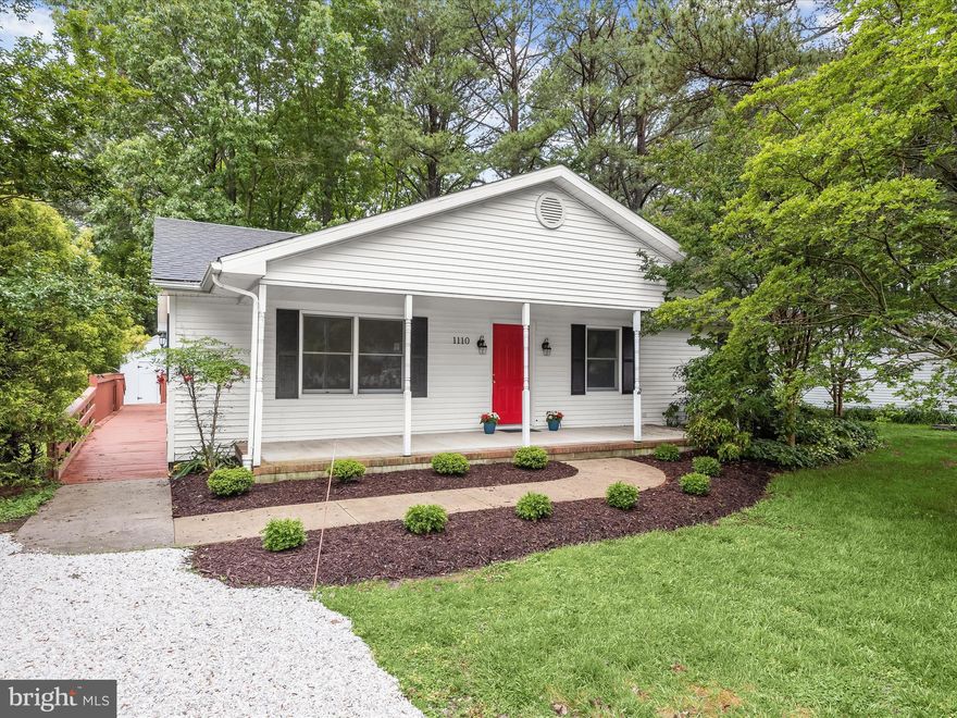 Welcome to this updated ranch-style home in the water-privileged community of Rio Vista. Nestled near downtown St. Michaels, this charming residence offers access to a community marina and boat ramp on Spencer Creek and park with picnic area on the scenic Miles River. Enjoy the convenience of local shops and waterfront dining just moments away. The home’s exterior boasts a covered front porch and new landscaping, creating a welcoming curb appeal. Step inside to find a spacious living room with beautiful laminate plank flooring and a neutral paint color that flows throughout the house. The kitchen features 42-inch beadboard cabinetry, granite counters, and stainless steel appliances, perfect for culinary enthusiasts. Designed with a split bedroom floor plan, the primary bedroom at the back of the home provides a private retreat with a renovated en-suite bath, showcasing a seamless entry floor-to-ceiling tiled shower with grab bars. On the opposite side of the home, another bedroom with an en-suite bath and two additional bedrooms sharing a full hall bath offer ample space for family and guests. Additional features include a crawl space encapsulated in 2016, a back half roof replacement in 2023, and a floored attic with pull-down stairs for extra storage. The resurfaced deck overlooks a serene backyard with mature trees and a storage shed, providing a peaceful outdoor escape. A ramp off the driveway connects to the deck, offering side door access into the home for added convenience. Experience stylish living in a vibrant community with this beautifully renovated home in Rio Vista. Property Updates: stove, dishwasher & microwave, interior paint, flooring, deck resurfaced, back half roof replacement, landscaping, full bath renovated, and crawl space encapsulated.