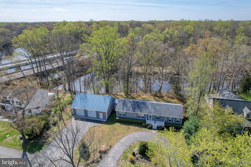 Motivated seller—priced below appraised value! Appraised at $534K, now reduced for a quick sale. Don’t miss this rare opportunity to walk into instant equity. Spacious 3-bedroom, 2.5-bath rancher with pole barn on the upper Chester River! Step inside this private waterfront retreat to a welcoming living room featuring a cozy propane fireplace with a beautiful stone surround. The spacious primary suite offers an oversized bathroom with a garden tub beside a second gas fireplace, a walk-in shower, and a separate water closet.

The dining room opens to a back deck overlooking the river, complete with a retractable awning—perfect for relaxing and enjoying the water views. The kitchen is designed for both function and style, featuring an island, double ovens, and a large stainless farmhouse sink with views of the river. Two additional bedrooms share a full bath. Just off the kitchen is the laundry room along with a convenient half bath.

A breezeway connects the home to an impressive 1,200 sq. ft. pole barn, which includes stairs to a second level and a motorized lift for easily moving items upstairs. The home has been meticulously maintained, including regular HVAC servicing, resealed blacktop driveways, and proactive updates like replacing the water heater.

Enjoy life on the river—perfect for kayaking, fishing, and even crabbing from your own property. The home sits elevated on a hill well above the floodplain.  Buyers may have the option to add steps down to the water and potentially a bulkhead or small pier (to be confirmed with the county).

Conveniently located with quick access to Rt. 301 for commuting to Middletown ( 16 miles), Chestertown ( 12 miles), or the Chesapeake Bay Bridge ( 40 miles). Food Lion is also less than a mile away. The property is serviced by public water and sewer and also includes a well for irrigation. Professionally landscaped and being freshened up for spring—be sure to add this one to your watch list! All offers considered!