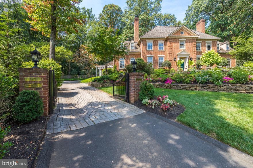 Handsomely sited up a private drive and known as “The House on The Hill,” with a gated entrance this exceptional house offers 7,650 sf of living with five bedrooms, seven fireplaces, custom millwork, exceptional designer appointments and magnificent grounds. This thoughtfully designed floor plan is ideal for formal entertaining or casual family living and flows nicely from inside to the outside brick terraces and pool area. Between 2014 and 2017, the owners expanded the kitchen (with Case Design and McIntyre-Mansy Associates) and the owners’ suite and completed renovations throughout the house including all the bathrooms. * 

The grounds are meticulously manicured with a rich variety of seasonal blooms and extensive brick paths, a large paver parking deck adjacent to the garage and a handsome pergola side entrance.  The very private backyard, which is totally fenced and backs to parkland, has a beautiful pool and an expansive brick terrace which offers great flow from the inside of the house to the pool area for grand events or small family gatherings. *

The main level has a grand gracious foyer that feels like a classic Virginia estate home with sweeping stairway, spacious light filled rooms with high ceilings and stunning arched windows and hardwoods throughout, a great room with 11 ft ceilings, private library with built-ins, an expanded gourmet kitchen with a large breakfast room with table space for ten. * The expanded European kitchen featuring aged wrought iron hardware, two very sizable eat-up kitchen bars, top of the line appliances including two dishwashers, three garbage disposals, two sets of ovens and two refreshment drawers, handmade toile tile and a large butler’s pantry area with glass front cabinets. There is a main level laundry next to the kitchen for easy washing of sports gear and kitchen linens. This is in addition to an upper level laundry. * The handsome mudroom is finished with brick floor and wall of lockers for each family member’s coats, shoes and backpacks. *

The upper level has hardwoods throughout and the same rich finishes as the main level. The primary suite overlooks the backyard and has a fireplace, dressing room and a stunning marble luxury spa-like bath with a designer free standing tub and skylights. The upper level is complete with three additional bedrooms, one ensuite and one Jack & Jill bath and the second laundry room. *  The lower level has an exercise room complete with special flooring and a mirror wall, a wide-open recreation room ready, 5th bedroom and a charming full bath and a utility/storage room. *