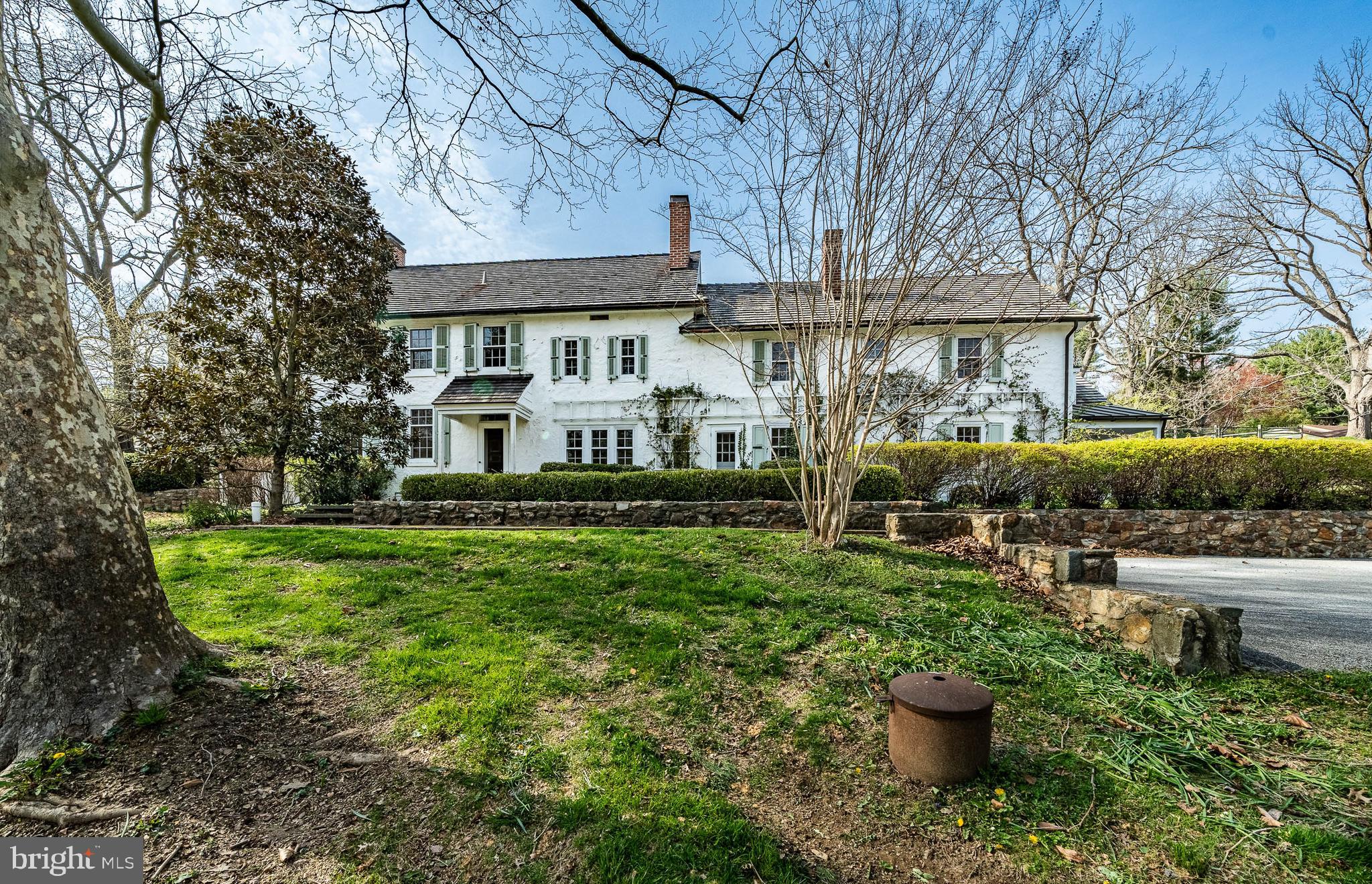Discover timeless elegance at 401 West Locust Lane in Kennett Square, PA—a distinguished manor home originally built in 1822 and thoughtfully expanded over the centuries. Set on 6.9 lush acres, this 4,353 sq ft residence seamlessly blends historic charm with modern amenities. 
The main house features five spacious bedrooms and four and a half bathrooms, adorned with wide-plank hardwood floors, exposed beams, and five fireplaces with original mantels. The gourmet kitchen boasts a Viking 6+ burner stove with griddle and dual ovens, a second gas cook top, dual sinks, and extensive soapstone countertops. Recent enhancements include a mudroom, pantry, and a screened porch off the primary suite, offering serene garden views. 
A detached 3-car garage includes a charming one-bedroom, one-bathroom apartment—ideal for guests or extended family. The property also features stone terraces, mature gardens, and fenced areas perfect for recreation or pets. Modern upgrades encompass central air conditioning, radiant heat in brick floors, updated plumbing and electrical systems, and a generator. Public water and sewer services have been added for convenience. 
Located within the esteemed Unionville-Chadds Ford School District, this estate offers proximity to downtown Kennett Square’s vibrant dining and shopping scene, the Kennett Square Country Club, and major routes to Wilmington and Philadelphia. Experience the perfect harmony of historic character and contemporary living in this exceptional property.