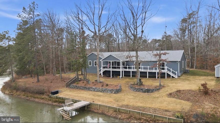Lakefront living reimagined to fit your needs! ...Don't miss out on this rare opportunity to own a beautiful over 2000+sq ft custom built lake home on a private cul-de-sac overlooking the water.  With over 220Ft of Lakefront and a personal dock this ranch style home is already handicap equipped to fit your needs for a lifetime of amazing views.  This thoughtfully designed home features a large foyer and living room area with open views to the water so you can sit and enjoy your coffee inside or outside while watching the sunrise over the water. The kitchen has lots of storage space with a butlers pantry, luxury vinyl tile flooring, beautiful quartz countertops, as well as backlit cabinet lighting, and a custom backsplash design. 
All the bedrooms are good sizes with built in closet shelving. And the oversized primary bedroom ensuite that has wonderful Waterview, a balcony area, and easily room for a sitting room or office area too. The primary bathroom has luxury vinyl tile floors, quartz counters, walk in tile shower, and a large walk in closet with custom built ins. The utility room is designed as a multifunctional laundry room with utility sink, and added storage cabinets and countertop space. There is an extended covered back porch perfect for enjoying not only lake views but also the wildlife and the many species of local and migratory birds including bald eagles and osprey that visit the lake. There are steps leading down to the water and private dock where there is great fishing and room for small boats. In addition, the backyard is fully landscaped & there is a whole yard irrigation system that feeds off the lake to keep your grass looking pristine. The extended oversized garage has room for anything you can imagine with a Sauna and/or hot tub hook up area, outdoor shower,  gym space, three bays, and room for your golf cart or tractor.  Plus, the whole house is handicap equipped with  4' wide hallways, 3' wide doors, pocket doors, and a concrete wheelchair ramp in the garage so you can truly make this your forever home. Paved driveway on cul-de-sac lot and storage shed (last section of the road is set to be paved this year by the community). Lake Land'Or is a wonderful private gated lake community with tons of amenities for the family to enjoy such as a gym, clubhouse, archery range, basketball courts, lake access, playgrounds, pool, & so much more.  This community is also  easily accessible from I-95 or Rt 1. (2.58% assumable loan option could be explored for VA buyers as well) Come out and tour this house before its gone!