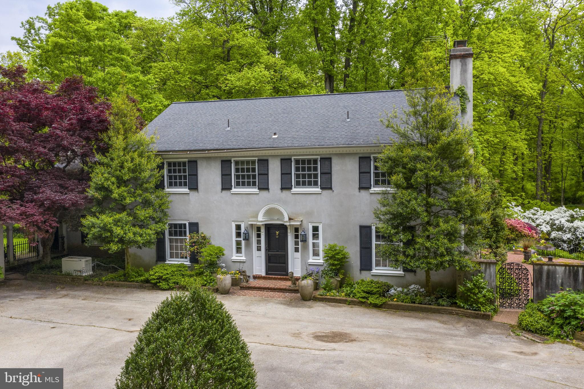 This property is a rare find in Easttown township! Situated on 19 acres of beautiful and private land, this stately colonial home is surrounded by woods and ponds. Close to everything, but set back down a winding drive, this land and lovely setting with surroundings is protected by Brandywine conservancy. You will have complete privacy to enjoy all the beauty nature offers. This home is a must see with many special features including gorgeous mouldings and woodwork and hardwood floors throughout. Enter the front door into the entry hall with brick flooring, and gracious staircase with wainscotting. Step down into a huge living room with an impressive fireplace, chair railing and french doors leading out to a pergola covered flagstone patio. The equally large dining room will provide space for formal entertaining and features a fireplace with marble surround, flanked by deep window seating, and more french doors to the patio. From here, go through to the neutral eat in kitchen with white cabinets, plenty of counter space, double ovens, with pretty views from your window and a door with yet another access to the backyard and patio. Tucked behind the kitchen is a family room with vaulted ceiling, wood beams, fireplace and steps to a fabulous loft area outfitted with built-ins and used previously as a cozy library. This space also has a full bath and laundry room and can easily be used for a first floor master/in-law suite, if desired. Also on the first floor is a home office with wainscotting, build in shelving and hallway half bath. Upstairs there are 3 large bedrooms sharing a hall bath. The master suite at the other end of the hall is large, with a fireplace and a "juliet" balcony overlooking the patio, pool, and ponds. Outside, there is a front courtyard, detached 2 car garage with fenced in side area and additional space for parking just outside the courtyard. A whole house generator has been installed by the owner. Decorative arched wrought iron gates lead from the courtyard to the backyard, flagstone patio and pool. Overlooking the patio, set down the steps are three ponds that are feed from a meandering stream. Waterfalls and bridge walkways entice you over to the ponds. The middle pond is home to a group of large koi fish. The home was originally built by the owner, whose family gifted them the land. The land has been in the family for over 100 years. Close to EA, Newtown Square, Paoli, and Wayne. Awarding winning Tredyffrin-Easttown School District. Truly a special property, to be cherished and passed onto the new owner.