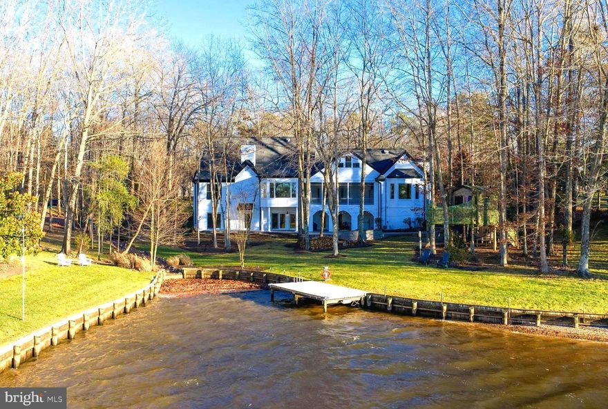 Extraordinary lakefront residence in Fawn Lake, set on 1.32 private acres with breathtaking sunset water views. This three-level, custom-built home was completely and thoughtfully renovated in 2025, offering an exceptional blend of refined luxury and modern design. The main level features 10-foot ceilings and an impressive two-story, wide foyer that creates an immediate sense of scale and elegance. A separate dining room is ideal for formal entertaining, while the light-filled living room and adjoining sunroom are designed to capture panoramic views of the cove. The gourmet kitchen has been fully remodeled and includes a large island, a custom farmhouse shiplap hood, Café white matte appliances with brushed gold fixtures, and an expanded walk-in pantry with an added butler’s pantry area. The main level also offers a stunning lake-view primary suite featuring two walk-in closets, fireplace and a spa-inspired bathroom with heated tile flooring.  A well appointed laundry room with custom built-ins and a convenient half bath complete the first floor.  New beautiful hardwood floors extend throughout the home.

The upper level provides two additional spacious bedrooms, each with its own en suite bathroom, offering comfort and privacy for family or guests while maintaining the home’s elevated design and functionality.

The lower level is fully finished and opens directly to a beautifully arched, columned brick patio and the stunning backyard facing the lake. This level includes three bedrooms, a private office, a dedicated fitness room, and a generous living space, all with direct access to the outdoors and tranquil cove views. A luxury full bathroom with heated flooring and a cedar walk-in closet complete this level, creating a comfortable and private retreat for guests or extended living.

A newly created, immersive entertainment retreat on the lower level adds a distinctive and memorable feature to the home, designed as a sophisticated lounge and bar area with a concealed door leading to a private office or speakeasy-style hideaway, offering both discretion and versatility.

A major whole-house renovation also includes the addition of a third-floor office retreat overlooking the lake, along with expanded recreation, gym, and living areas that elevate the home’s flexibility for work, leisure, and entertaining.  A new dock for easy lake acesss is steps away. The house includes a whole-house generator, and a brand-new commercial-grade hot water heater. All bedrooms facing the backyard enjoy peaceful cove views and spectacular lake sunsets, making this a truly rare lakefront offering in one of Fawn Lake’s most desirable settings.

Enjoy the best of both worlds with lakefront living on a private estate while enjoying the finest amenities that Fawn Lake has to offer. The Fawn Lake community provides an unparalleled luxury lifestyle with exceptional amenities, including gated 24 hr security, a recreational boating lake, sandy beach, community pool and clubhouse, renowned Arnold Palmer golf course, tennis and pickleball courts, soccer and baseball fields, miles of scenic walking trails, a dog park, marina, on-site restaurants, playgrounds, and a variety of clubs and activities for all ages. Experience the pinnacle of resort-style living, where every day feels like a vacation!