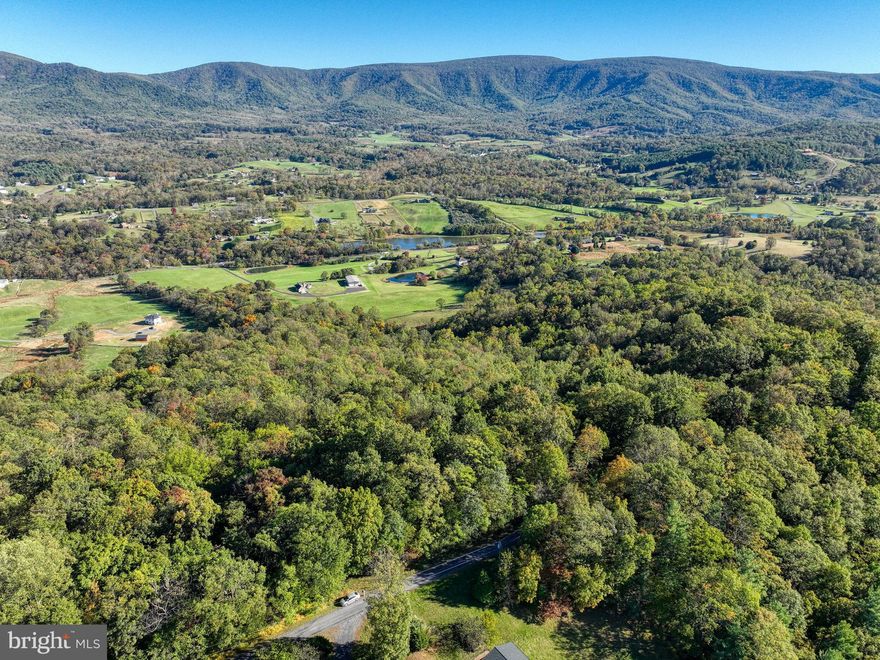Back on the market! Rarely available lot in Seven Oaks, a private community of 16 homesites perched on Long Mountain with dazzling views of the Shenandoah Valley. Build your dream home in a community that covets privacy and peace (HOA restrictions do not allow short-term vacation rentals). Clear a few trees to enjoy an east-looking vista of pastures, woods and mountains stretching for MILES!  Lot is approved for a 4-bedroom home with conventional septic, and includes a proposed drainfield site. Real-estate signs and red ribbons on trees mark approximate property corners. Gravel road up the mountain is well-maintained by the HOA; surrounding roads in the valley are now paved. Located just 10 miles from Front Royal, minutes to Shenandoah National Park, the Shenandoah River, and Andy Guest Park--a nature-lover's paradise!