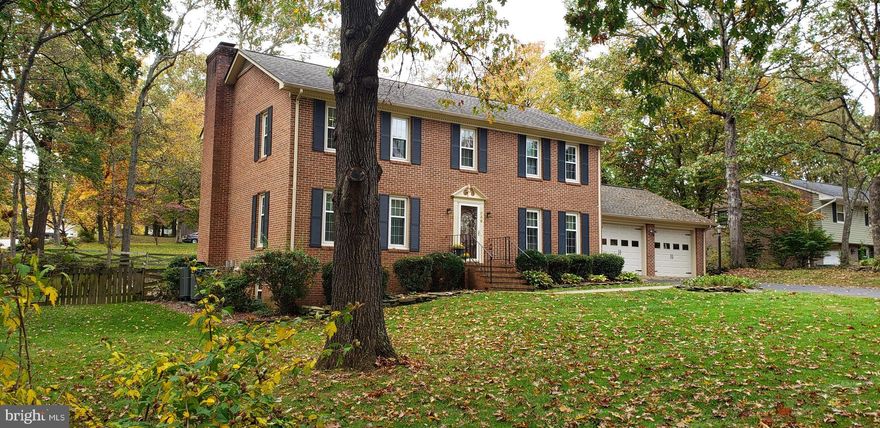 You will fall in love with this beautifully appointed all brick home situated on a picturesque landscaped lot located within minutes of I95, schools, shopping, Brooke VRE, Parks & the YMCA. Where to begin.....numerous high end upgrades through-out! Beautiful hardwood and slate tile floors on the main level welcome you. The updated kitchen offers warm pecan cabinetry,  spacious center isle, silestone counters,  tile backsplash, under & above cabinet lighting, & ss appliances. Relax in the sun filled family room accented with hardwood floor, gas fireplace and beautiful views of the rear yard. The upper level offers 4 spacious bedrooms.  The master bath boast an updated walk-in shower with pebble tile, multi-shower head & teak  seat. The upstairs hall bath has been updated as well! The unfinished walk-out basement with masonry fireplace is ideal to finish as you please as well as ample storage.  The manicured yard is sure to please and perfect for entertaining. The fenced rear yard offers a spacious deck w/lighting, stamped concrete patio and electric retractable awning. There is also additional storage in the 8"x12" shed. And if that's not impressive enough all windows replaced with vinyl tilt-in, new Andersen Sliding Glass Door to deck, 7 zone irrigation system, newer roof with gutter guards and 2 zone hvac systems. Yes, this home is move-in ready and could be yours for the New Year! Happy Holidays