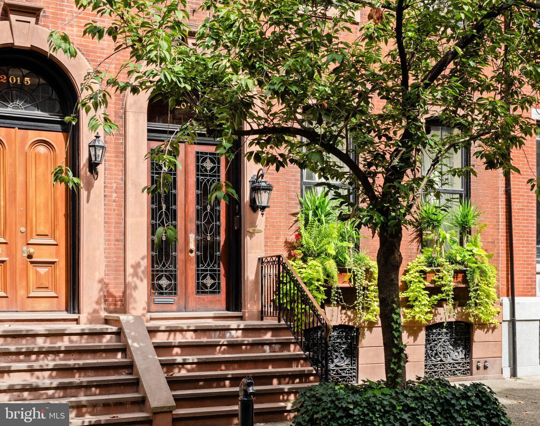 The striking 23’-wide historically significant brownstone at 2013 Delancey Place presents an opportunity to acquire an extraordinary property designed by the illustrious William Eyre. A masterpiece of architectural grandeur, artisanal craftsmanship and timeless elegance.
The Parlor Level’s wide entry gallery, grand staircase and 11.5 foot mirror framed in 24-carat gold welcomes you to the home, setting the stage for the glorious charm of yesteryear with original doors, fireplace mantels, flooring, and moldings—each telling stories of their own. The first floor greets you with impressive 12.5-foot ceilings and one of the nine fireplaces that grace this home, creating an atmosphere of warmth and sophistication.
The second floor receives you with an opulent hall and features a new Johanne Hudson kitchen with Calcutta Gold and Pietra del Cardosa slabs, an expansive dining room with Venetian plaster walls, original french doors and perched at tree level, a remarkable 600 SqFt great room of your dreams with an original fireplace mantle, paneling, figurines, moldings and stained glass under inspiring 10.5-foot ceilings. Tucked at the rear of the floor is a bar room where peeling off to pour your guests a drink is a breeze. Share a cocktail and admire the fireplace, columns and rounded window bay that adorn this room.
Ascend to the third floor, where the primary suite awaits, complete with a magazine-worthy bathroom showcasing exquisite custom bronze and iron detailing by Amuneal, book matched imported Italian black Carrara marble, heated floors, arched halls and Venetian plaster. The third floor also hosts a guest suite with a full bathroom stretching the entire front of the home.
The fourth floor provides two additional large bedrooms, perfect for accommodating a variety of needs and a shared full bathroom in the hallway. Additionally there is a middle room currently used as a walk-in dressing room wrapped with bespoke mahogany doors and closets.
Spanning over 6,000 square feet on a 93’-deep lot through to Cypress, this home offers a canvas of possibilities with its graceful layout and 1,000 square feet above grade on the first floor currently un-finished ready for your personal touch. ** Virtual renderings show what the 1st floor could look like if you were to bring the entertaining areas to the 1st floor **
Nestled on Philadelphia’s most coveted block, picturesque, tree-lined and graced by the most imposing series of impeccably-preserved townhouses in the City, this property offers a one-car garage—a true gem in city living. Superlative elements abound throughout the interiors with major systems meticulously maintained, this home is as functional as it is beautiful. Whether you're captivated by its historical allure or eager to add your own chapter, 2013 Delancey Place is ready to welcome you.
By appointment only.