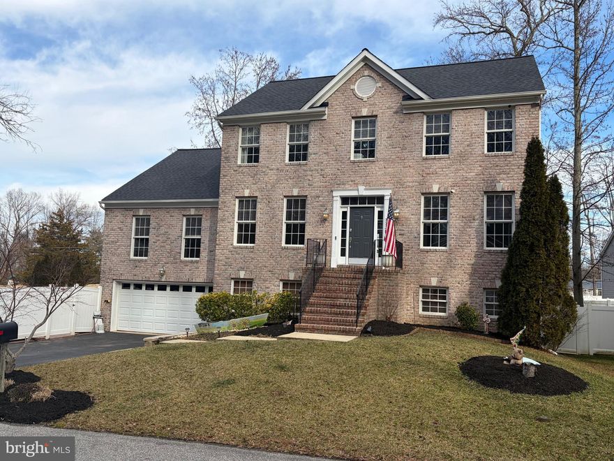 Shows like a model! This stunning 5-bedroom, 4.5-bath, two-story colonial offers exceptional space, style, and flexibility. The main level features a primary suite, perfect for multigenerational living or guests, plus a second primary suite located on the upper level. Custom touches include Crown Molding on the main level. The gleaming kitchen showcases maple cabinets, granite countertops, stainless steel appliances, and a breakfast nook, with sliders leading to a deck and stairs to the backyard.

Upstairs, the spacious second primary suite features elegant double-door entry, Tray Ceilings and Crown Molding plus a private en suite bath with luxury soaking tub. Additional bedrooms share a hall bath, and the conveniently located upper-level laundry room makes daily living easy. Matching Maple Bathroom cabinets and granite tops too!

The finished lower level is an entertainer’s dream, offering a built-in recreation bar, full bath, and walkout access to your private backyard. Step outside to enjoy the stamped concrete patio with Hot Tub for those cool nights, fully fenced yard with 6-foot white low-maintenance privacy fencing, storage shed with electric, and kayak rack. Additional parking space for campers, boats or RV. New 50-year architectural roof just installed with transferrable warranty.

Located in the waterfront community of Glebe Heights, residents enjoy access to a boat ramp, community dock, and swimming area—perfect for embracing the South River and Chesapeake Bay lifestyle. Convenient to Annapolis shopping and dining, with easy commutes to Fort Meade, Washington, D.C., Baltimore, and BWI. This home blends comfort, space, and waterfront living in one of Edgewater’s most desirable communities.