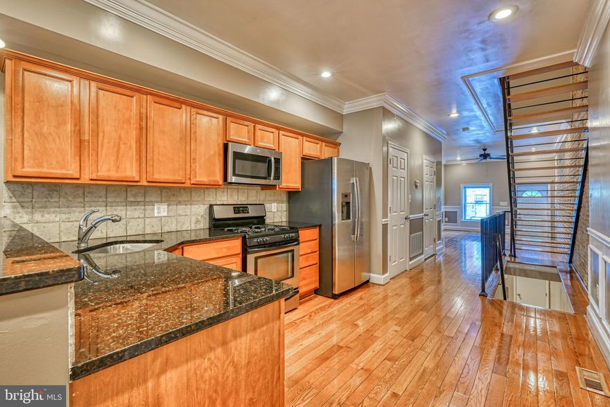 You must see this quality renovation with its meticulous attention to detail. The spacious dining area and granite kitchen with a full tile backsplash lend an air of luxury.  The master bath, boasting a separate vanity area and a soothing jacuzzi is Inviting in every sense, the bedroom offers stunning ceiling detail alongside a delightful deck at the rear. The 10+ feet ceilings and exposed brick contribute to the warm ambiance.  The fully finished lower level also with high ceilings can easily be used as an additional bedroom or for entertaining purposes.  Situated in close proximity to renowned landmarks such as The BMI Museum, Carroll Park, and the Stadiums, this exceptional property holds the potential to become your very own sanctuary.  Don't miss out on this extraordinary opportunity.