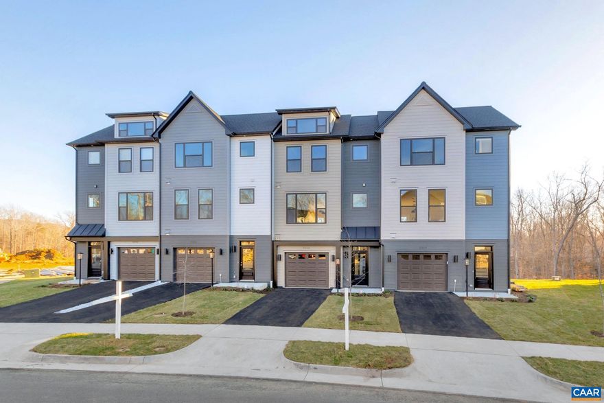 JULY DELIVERY. This HIGHLY custom Bainbridge has it all. The interior unit features 3BR, 3.5 bath, flex/rec/office in the basement area & attached garage. A thoughtfully designed open floorplan includes on the main level, the spacious great room with a fireplace, gourmet kitchen, farmhouse sink, double oven, oversized 9ft island with granite,  soft closed maple cabinetry and wood flooring throughout the main level. The 8x20 trex screened porch backs up to trees, great for entertaining and morning coffee. The upper level has the primary bedroom with the bath having granite countertops, ceramic tile flooring, and a roman shower with a frameless shower door, 2 additional bedrooms, full bath, and laundry. Belvedere is centrally located, to the Downtown Mall, UVA, RT 29 shopping & Rivanna Trail. LAWN CARE AND TING FIBER are included in the HOA. All homes are third party tested for energy efficiency and come w/Pearl Gold certification. Interior selections are attached. Similar photos.,Granite Counter,Maple Cabinets