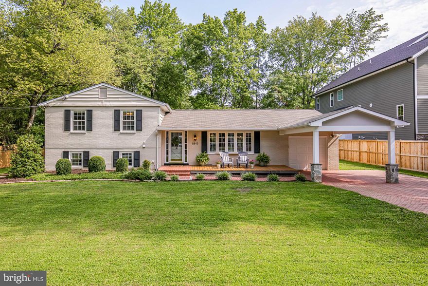 *****Offers will be reviewed on Tuesday, August 17 at noon****
Welcome home to 8845 Fort Hunt Road! Located on a quiet street across from the serene Fort Hunt Park, this beautifully updated home is walkable to Waynewood Elementary School. It boasts a lovely open concept floor-plan for easy living and entertaining. The renovated kitchen has stainless steel appliances, gas cooking with a double oven, and an 8 ft. island with a gorgeous maintenance-free honed quartz countertop. Oversized classic lantern light fixtures round out this high-end look. There is a primary suite (with a full bath) upstairs, and 2 additional generous sized bedrooms. The updated hall full-bath has a double sink with a marble countertop. The fully finished walk-out basement has a large rec-room (with built-ins) and a 4th bedroom, both loaded with closets. The downstairs powder room is large enough to be converted to a full bath. Take in the outdoors and the big backyard on the sizeable and private paver patio. A main floor laundry/mudroom, garage and extra garage/gym/storage space make this a truly unique property in Fort Hunt. This home has it all – location, updates, style and storage!