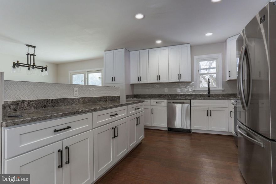 Corner lot located in established community of Molesworth. Just completed renovations include wood floors on main level and carpet in the basement, removal of wall to open the living area, white shaker soft-close kitchen cabinets with matte black hardware, granite counters, stainless steel appliances, single bowl stainless sink with matte black faucet, custom tile backsplash in kitchen, sliding glass door to 16x20 maintenance free composite deck, tile floor, vanity, toilets, shower pan and tub in bathrooms, electrical and plumbing fixtures, interior doors, painted wood burning fireplace, drywall repair and paint throughout, HVAC inspection, roof inspection and maintenance, garage door, mulch and front landscaping. Garage door in photos has been replaced and the fireplace in the photos has been whitewashed. The exterior will be power washed before settlement. All work has been completed with a licensed contractor and permitted. Nothing to do but move in. See disclosures for details.