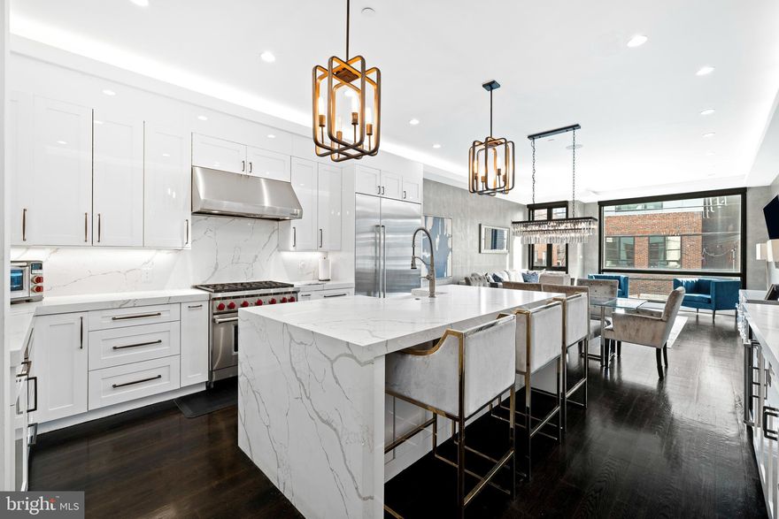 Indulge in the epitome of urban sophistication with this exquisite luxury townhome. Nestled in the heart of Northern Liberties, this meticulously crafted residence seamlessly blends modern elegance with unparalleled comfort.  Every detail has been meticulously curated to elevate your lifestyle, with seamless indoor-outdoor flow and panoramic views, this townhome offers the ultimate retreat for those accustomed to the finest things in life.  This stunning home has 4 years remaining on the tax abatement and offers 4-bedrooms, each with an en-suite bath and walk-in closest, a luxurious gourmet kitchen with a large kitchen island with waterfall quartz countertop, solids stone backsplash, Sub-Zero refrigerator & freezer, Wolf 6 burner stove, pantry with coffee bar, second sink & beverage fridge. A custom-designed home gym (easily convertible to a private office) includes a kitchenette for ultimate convenience. The 5-stop elevator ensures effortless access to every floor, while the heated 4-car garage complete with an EV charger and workstation caters to both luxury and functionality. A state-of-the-art Russound surround sound system with 12 speaker zones envelops the home in immersive audio, while the first-floor bedroom is pre-wired for a 5.1 surround sound theater experience and also includes a bespoke meditation area with backlit onyx stone and gold leaf ceiling. The floor-to-ceiling windows have custom electric Hunter Douglas blinds and provide an abundance of natural light to stream through accentuating the exquisite white oak flooring and illuminating the spacious interiors. Ascend to the rooftop deck with Trex decking, cable ready and speaker system to savor breathtaking views of the city skyline, the perfect backdrop for entertaining or unwinding in style. Your peace of mind is ensured with comprehensive Xfinity security, hardwired interior/exterior cameras, and a Nest/Google Home-integrated network video recorder. This townhome is a sanctuary of modern luxury, designed for those who appreciate the finer things in life.