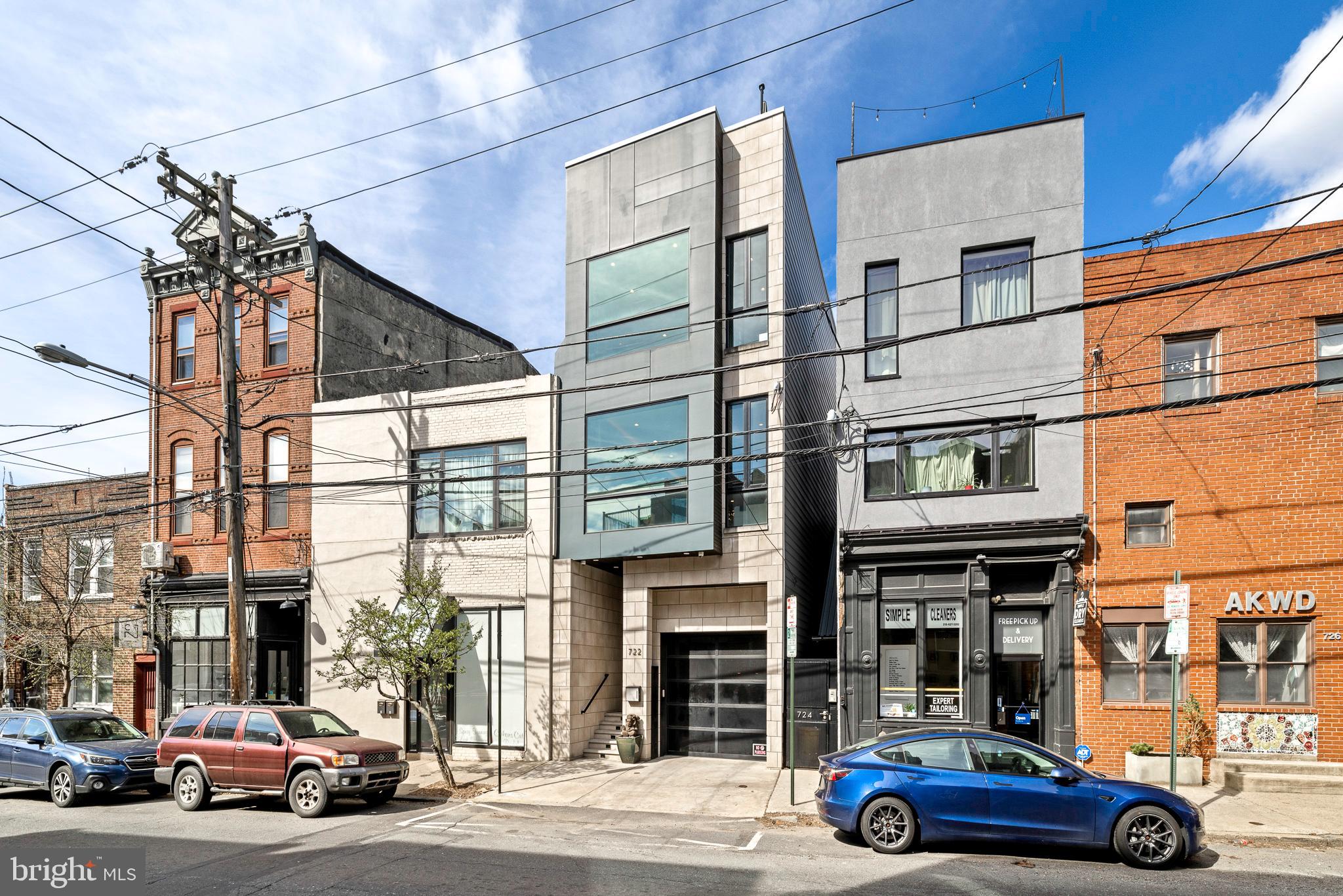 Indulge in the epitome of urban sophistication with this exquisite luxury townhome. Nestled in the heart of Northern Liberties, this meticulously crafted residence seamlessly blends modern elegance with unparalleled comfort. Every detail has been meticulously curated to elevate your lifestyle, with seamless indoor-outdoor flow and panoramic views, this townhome offers the ultimate retreat for those accustomed to the finest things in life. This stunning home has 4 years remaining on the tax abatement and offers 4-bedrooms, each with an en-suite bath and walk-in closest, a luxurious gourmet kitchen with a large kitchen island with waterfall quartz countertop, solids stone backsplash, Sub-Zero refrigerator & freezer, Wolf 6 burner stove, pantry with coffee bar, second sink & beverage fridge. A custom-designed home gym (easily convertible to a private office) includes a kitchenette for ultimate convenience. The 5-stop elevator ensures effortless access to every floor, while the heated 4-car garage complete with an EV charger and workstation caters to both luxury and functionality. A state-of-the-art Russound surround sound system with 12 speaker zones envelops the home in immersive audio, while the first-floor bedroom is pre-wired for a 5.1 surround sound theater experience and also includes a bespoke meditation area with backlit onyx stone and gold leaf ceiling. The floor-to-ceiling windows have custom electric Hunter Douglas blinds and provide an abundance of natural light to stream through accentuating the exquisite white oak flooring and illuminating the spacious interiors. Ascend to the rooftop deck with Trex decking, cable ready and speaker system to savor breathtaking views of the city skyline, the perfect backdrop for entertaining or unwinding in style. Your peace of mind is ensured with comprehensive Xfinity security, hardwired interior/exterior cameras, and a Nest/Google Home-integrated network video recorder. This townhome is a sanctuary of modern luxury, designed for those who appreciate the finer things in life.
