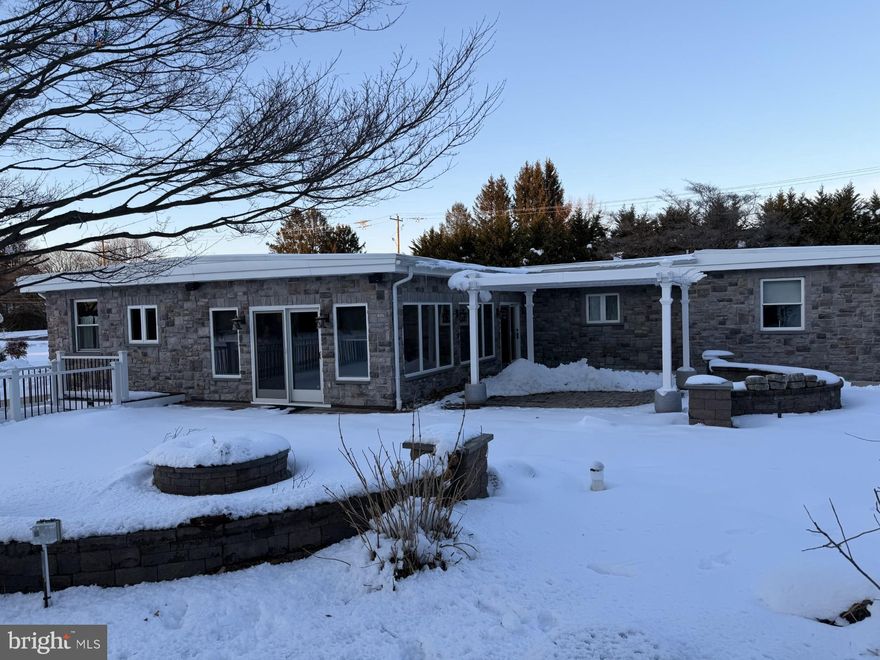 Gorgeous & exceptional 5 bedroom, 3 bathroom beautifully updated ranch style home with over 3,400 square feet of living space nestled on a large open and level 2 acre lot flanked by mature trees for privacy, in the top rated Garnet Valley school district. Centrally located to the Garnet Valley school campus, parks, Brandywine Youth Club practice fields and field house, dog parks, dance studios, Rachel Kohl LIbrary, playgrounds, and all commuting routes to corporate centers, restaurants, shopping centers, Media, Philadelphia, West Chester, Wilmington, the Philadelphia airport, commuter trains and much much more. This one of a kind home features a functional, spacious & open floor plan, affording luxurious single level living, with additional living space in the finished walk up basement that includes an additional bedroom, bathroom, 2nd kitchen and common area living space. Central to the main floor living area is an exquisite updated and upgraded chef's kitchen with lots of lovely cabinets, an over-sized center island with bar seating for five, pendant lighting, a wet bar, beautiful granite counters, stainless appliances including double ovens, cooktop, vent hood, a wine fridge, ice maker and much more. The kitchen walks out to an adjacent 4 season enclosed temperature controlled sunroom that has breathtaking views out over a beautiful paver patio with a pergola and a fire pit, but best of all are the lovely views out over the open and level 2 acre tranquil yard flanked by mature trees for privacy. The kitchen also walks out to a rear porch leading to the main driveway and detached garage. Adjacent to the kitchen is a spacious family room, and down the hall are four generously sized bedrooms including the primary suite (19x14') with a luxurious updated en suite tiled bath and a large walk in closet and there are three additional large bedrooms (13'x12', 12'x12' and 11'x10'); two have walk in closets and a third bedroom/office/flex room has double closets, and an additional beautifully updated hall bath. Completing the main level is a conveniently located laundry off from the family room. The finished basement with walk up exterior egress adds 1,084 square feet of added living area that brings total living area to 3,417 square feet, and is accessible via stairs from the family room of the main level and also has walk up egress to the rear patio; featuring a 2nd kitchen, a 3rd bathroom, a great room area and a 5th bedroom (14' x 11') with a closet.  Another fantastic feature of this exceptional home is a large 3 bay pole barn with an upper level loft, a side entry door and is also roughed in for a future bathroom installation if desired, suitable for many potential uses. The home has had a new roof installed (2022) and a new septic installed by Eldredge Septic 2026). This one of a kind home is turn-key move in ready - schedule an appointment to tour this exceptional property today before it's too late !!