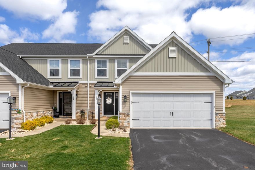 Wrap yourself in luxury with exquisite style, care-free living and easy access to everything you need. Impressive selections are displayed throughout this modern Azalea-style condo outfitted with luxury vinyl plank, soaring ceilings, and brilliant light fixtures. Step into the inviting eat-in kitchen equipped with a stylish island bar and stainless-steel appliances, effortlessly connecting to the family room. From here, enjoy easy access through sliding doors that open directly to the backyard patio. Uncover the first-floor primary bedroom suite, featuring elegant tray ceilings, a private full bath, and a spacious walk-in closet. The first floor also includes a convenient laundry room and half bath. Upstairs, you will find two bedrooms featuring ample closet space along with a full bath. The finished lower level provides endless possibilities, with an additional unfinished space ready for customization to suit your needs—whether it's a home office or extra storage. Residents can take advantage of the fantastic amenities at The Village of Nittany Glen, including a clubhouse, fitness room, cozy library, and a refreshing community pool. Note: lawn care & snow removal included in HOA fee.  Two-car garage.