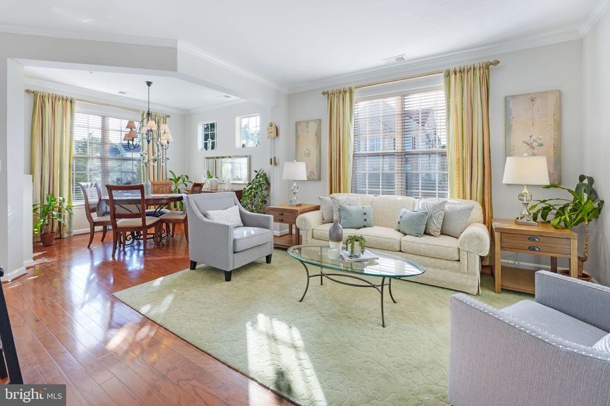 Beautifully Updated Corner 2-Bedroom Condo with 2 Full Baths AND Garage, offered by the original owner.  Discover the epitome of contemporary living in this updated corner unit, boasting a wealth of desirable features. As you step inside, you'll be greeted by the classic allure of real hardwood flooring that spans the entire space.  The open concept layout with high ceilings and windows on TWO sides bathes the interior in natural light, creating an inviting atmosphere that's both bright and welcoming. The well-designed kitchen features abundant storage in the 42" cabinets, convenient breakfast bar, sleek granite countertops, newer appliances, and the Italian backsplash all combine to infuse warmth and charm into the space, making it an inviting area for casual meals or entertaining friends and family.  Adjacent to the kitchen, the family room offers built-in storage, clever tuck-away systems for electronic cables, a thoughtfully renovated open wall with glass shelving, and a captivating two-sided gas fireplace, perfect for creating cozy moments.  The living and dining rooms are graced with natural light, enhanced by stylish ceiling fans, and designed with window placement that ensures privacy.   Retreat to the primary suite, a serene oasis that boasts ample space for relaxation, two closets, a ceiling fan, and a spa-like primary bath that promises a tranquil escape from the world.  One of the standout features of this exceptional condo is the bright, sun-drenched deck, offering rare, unobstructed views, perfect while savoring your morning coffee, unwinding after a long day, and enjoying the beauty of every season. Fresh upgrades abound, including a brand-new HVAC system, crown molding throughout, updated recessed and light fixtures, and replacement of all windows, ensuring your comfort and peace of mind.   This home is designed for convenience and enjoyment, with easy access to community amenities, including a pool, clubhouse, sport courts, wooded trails, a dog park, and a playground. An added bonus is the rare garage associated with this unit, providing secure parking for your vehicle and extra storage along with plenty of assigned resident and guest parking spaces.  There are 23 garages for 92 condos.  Opportunity is knocking!  Located just 15 minutes from National Landing,  DC, and in proximity to groceries, shopping, major commuter arteries, and public transportation, this hidden gem offers a tucked-away location with the convenience of urban living.  Don't miss the chance to make this remarkable property your own – it's a secret treasure trove waiting to be discovered!  (Please pardon our mess as we pack up to move :)