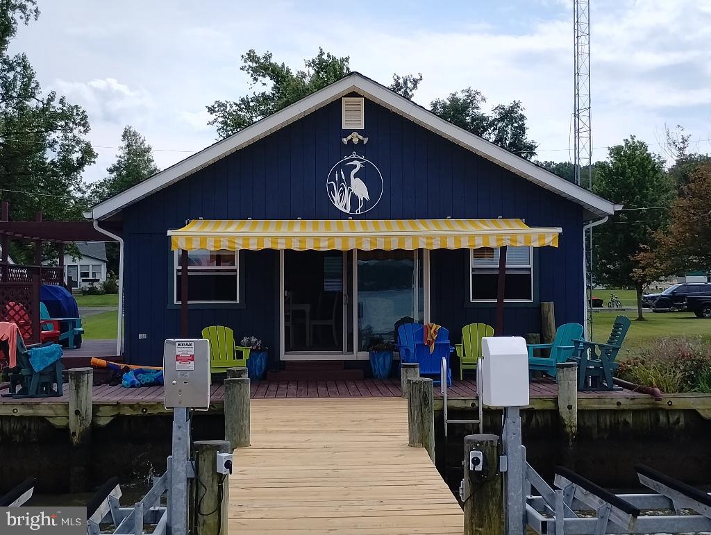 Rare WATERFRONT Property/ Vacation home for Sale... a true Turnkey Opportunity! Just a bit downstream from Chesapeake City, Md, near Port Herman and Hollywood Beach. Less than one hour from Delco, PA. Property is being sold fully furnished. Comes with an 85' foot dock (new decking). Dock has one Boat Lift and 2 Jet Ski Lifts. Catch Crabs and Fish right off the end of the dock!
Home features 4 Bedrooms, 2 fully-tiled spa-like bathrooms and an Open Concept Great Room with 9 ft ceiling. New mini-split HVAC system just installed.
Spacious Kitchen has all stainless-steel appliances, granite counter tops and a 4-stool Breakfast Bar, with Key-West styled, over-the-counter pendant lighting.
The over-sized Master Bedroom has a 10 ft Vaulted Ceiling and Master Bath ensuite. 3 other bedrooms.
From the Great Room, sliders open onto a large deck, right on the Water! Truly a dream come true! Large Canvas awning and Awesome Sunsets! Property is 250' deep and 50' wide. Large shed, 3-car parking pad & big, beautiful Vegetable Garden. Side deck off Kitchen for grilling! Roofs are just 4 years old.
This property is a Co-Op. Buying into Pleasure Shores, you become one of just 19 owners of a 60 Acre Parcel; 45 acres are farmland and 15 acres are residential homes on and along the water. There are no association fees.