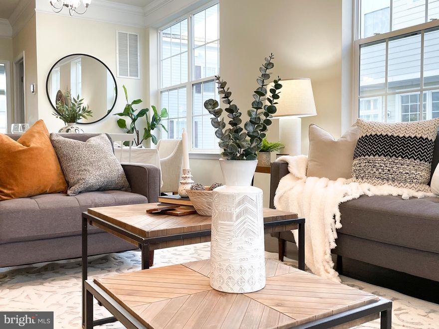 Price reduced another $15,000!! You cannot expect lower for this large model. If not sell, owner will just take off from market and turn to rental. The LARGEST model and MOST LUXURY setting at Townson Green! The same size in neighbor were sold for $557.5K and $529K early this year.   BEATIFUL as a model house! Enjoy the lower price and refinance when interest rate drops! 4-LEVEL END-UNIT townhome built in 2014, newer and green energy efficient built; End of group yet quiet, away from traffic. Gleaming hardwood flooring and crown molding throughout the main level. Freshly painted and new carpets in bedrooms, move-in ready. Attached 2-car garage, 2 decks to open gorgeous city view, 3 official bedrooms on upper level, one additional room at entrance level can be used as ENTRY LEVEL BEDROOM, playroom, study, gym... another spacious room on top finished attic with a bathroom - 2nd living room, entertainment room or the 5th bedroom whatever you choose to use, adjacent to large roof deck, oversized glass doors to open city view. Kitchen would be your favorite - with an island and a breakfast area, granite counters, 42" modern cabinets, stainless steel appliances,  adjacent to the 2nd deck/balcony. Master bedroom with walk-in closets and an in-suite bathroom, big tub, double vanity, frameless shower glass door, spacious and airy. Family room and dining area - open, full of lights, with a fireplace. Washer and Dryer on upper level. On all levels have high ceilings and large windows. Plenty of closets and storage space.  Neighborhood playground & rain garden and private neighborhood dog park! Convenient location in heart of Towson, steps away from gym, library, movie, Whole Food, and restaurants... This home has all.