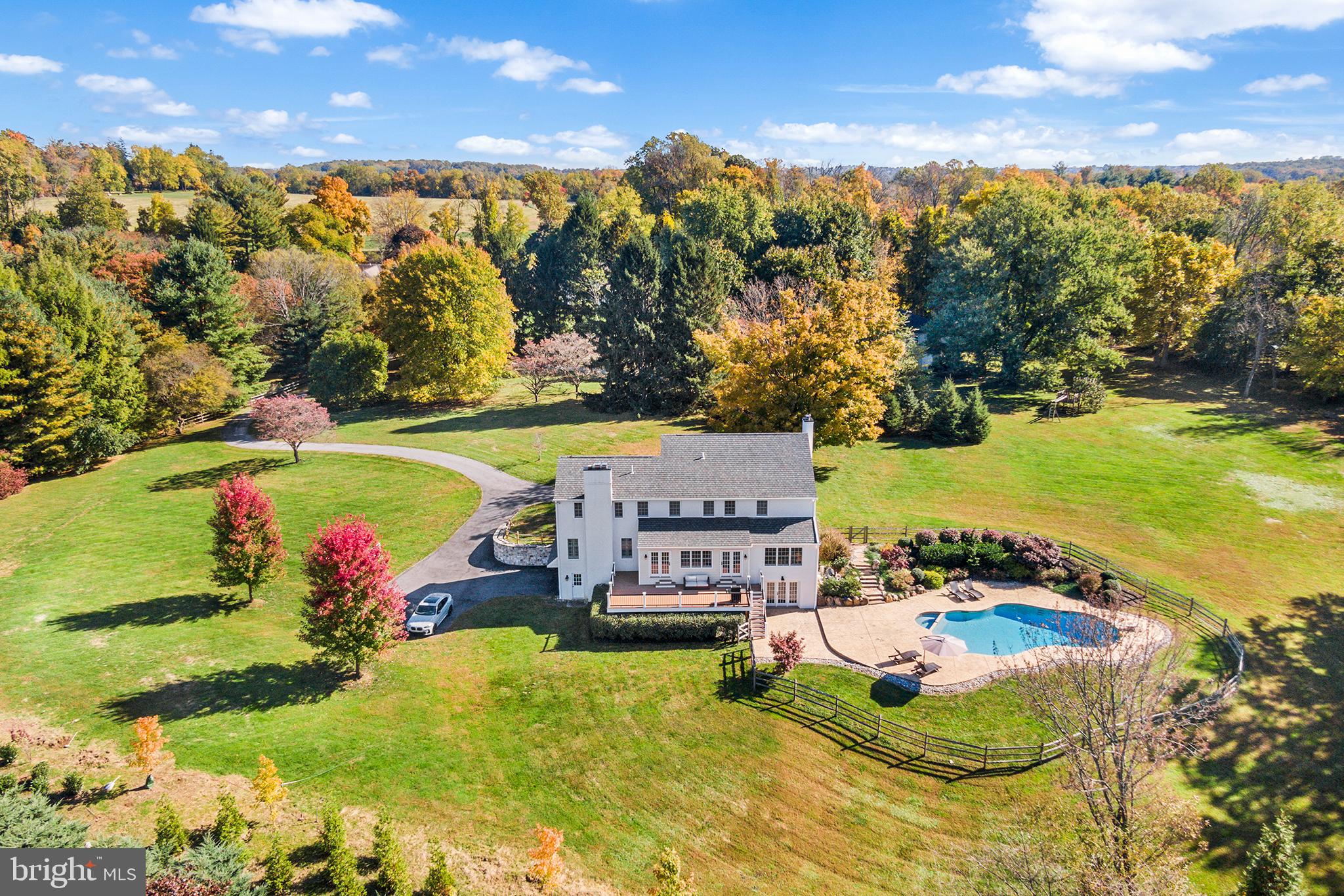 A rare opportunity in Easttown Township and top-rated T/E school district to own a captivating 4BR/3.5 Bath, 3,750 sf, 2.4-acre scenic retreat nestled down a long country drive. The current owner went to extraordinary lengths in 2014 to renovate practically every inch of this property with tasteful amenities including a beautifully landscaped pool and grounds, new deck. Interior finishes by master carpenter with exceptional attention to detail.
Enter to a two-story foyer and beautiful staircase providing a welcoming entry point to the first floor, which features hardwood floors, solid doors, upgraded hardware, classic living and dining rooms with detailed wainscoting and moldings, neutral paint, and high-end wood plantation shutters. A sun-drenched dining room connects to a designer kitchen with neutral cabinetry, granite countertops, new Subzero® custom-paneled refrigerator and new Bosch® dishwasher. The kitchen also boasts a vaulted ceiling breakfast area with picturesque vistas and French door access to the rear deck, yard, and captivating layered garden landscaped pool.
Adjacent to the kitchen you’ll find a generously sized family room with custom moldings, plentiful windows and a stone hearth fireplace. In addition, there is a fantastic office space with custom built-ins and spectacular views! Upstairs, in addition to 3 bedrooms (one of which has full bath), the spacious primary suite includes a fireplace, 2 walk-in closets w/built-ins, and a bathroom with granite top double vanity and oversized shower. Downstairs, the walk out garden level offers great finished space with LVT flooring and convenient access to the yard and pool.
2014 renovations include a new roof, new stucco, 2-zone HVAC, new deck, Anderson® windows & doors, completely renovated pool and spa, new bathrooms, and more. Fantastic location, minutes from downtown Berwyn and Paoli, along with several premier private schools and Main Line destinations.